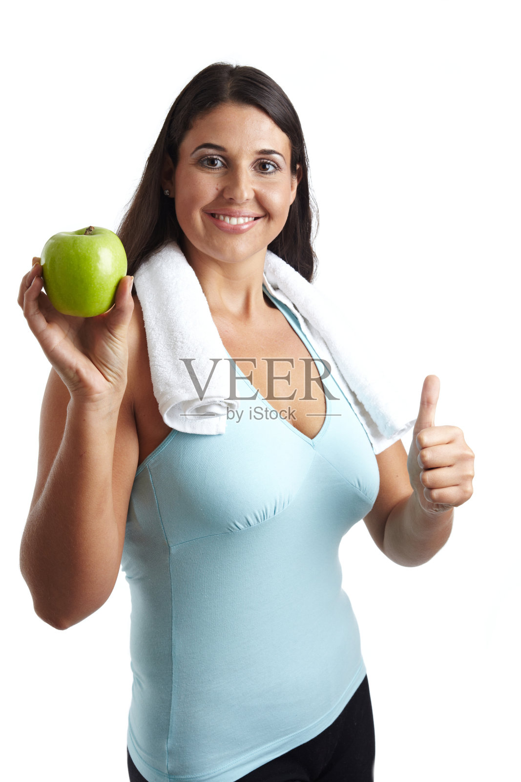 美丽的健身女孩展示一个苹果,竖起大拇指照片摄影图片