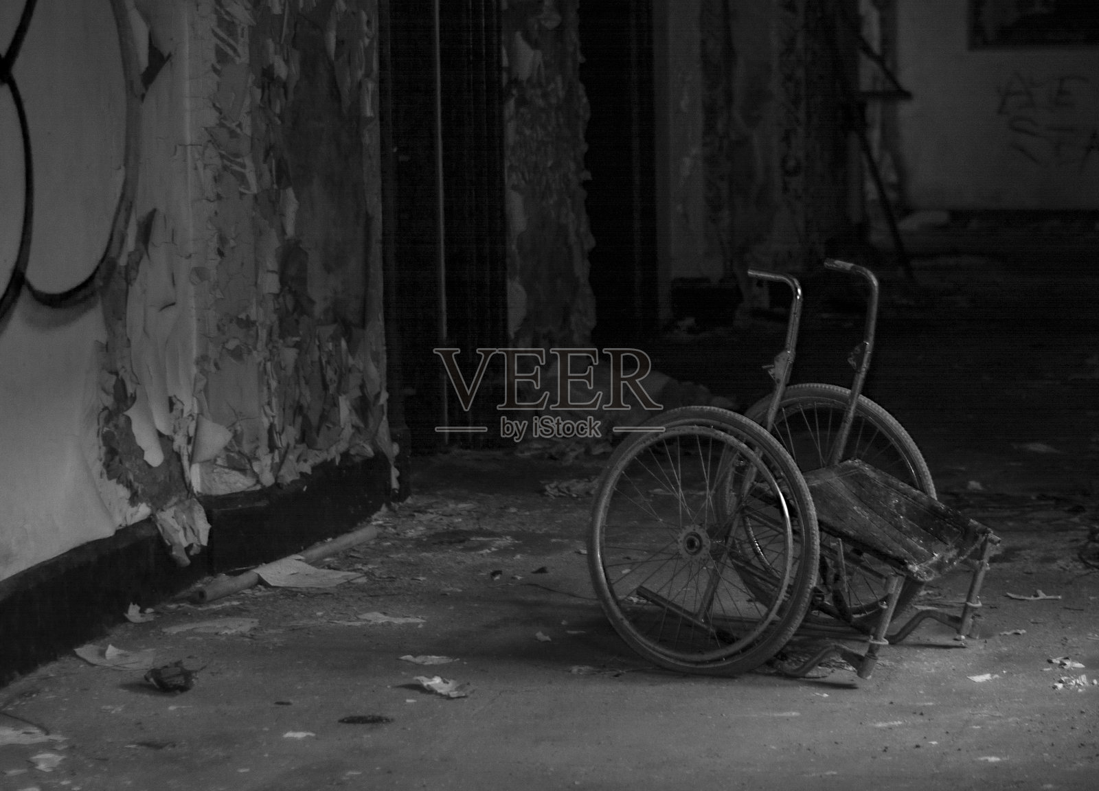 废弃的轮椅在一间黑暗的空屋子里照片摄影图片
