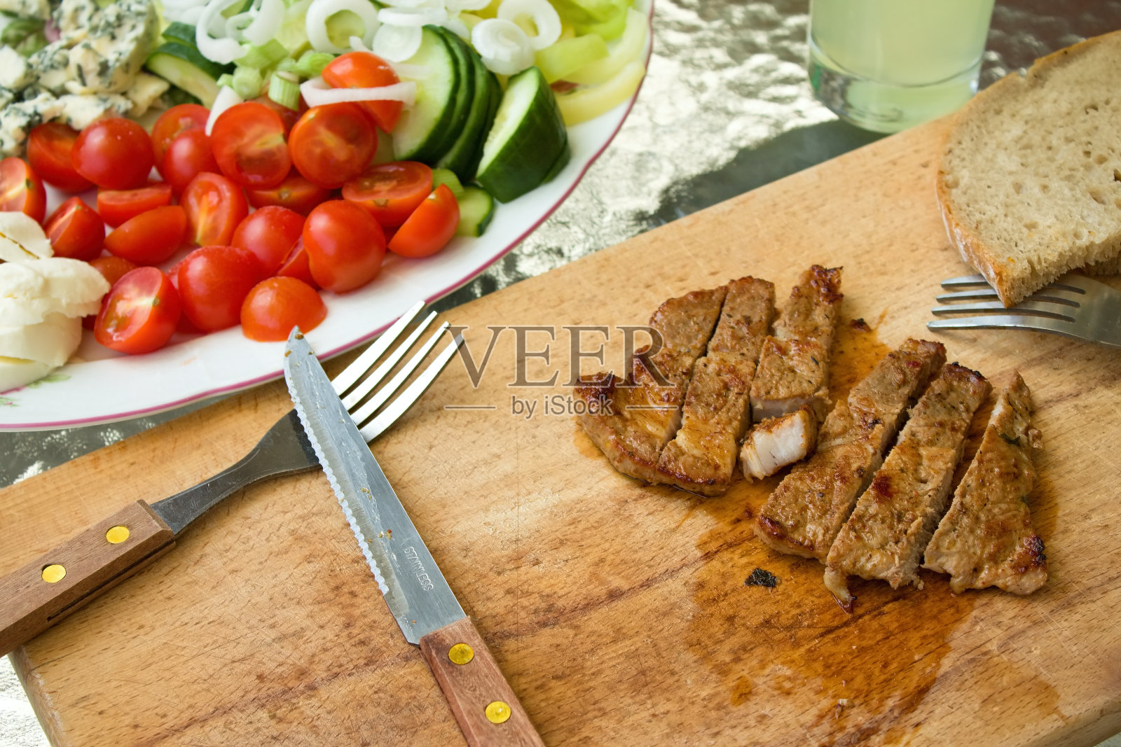 肉在切菜板上切成几条照片摄影图片