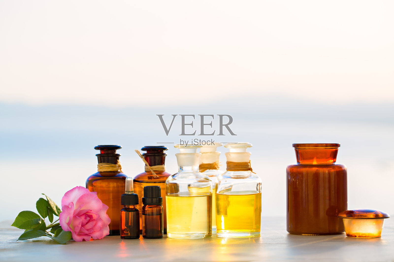 在日落时分,瓶中的Spa油照片摄影图片