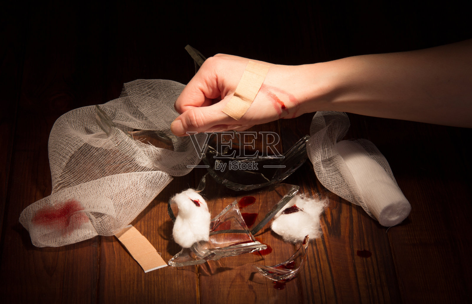 碎片玻璃碎片,受伤的手,绷带,黑色胶带。照片摄影图片