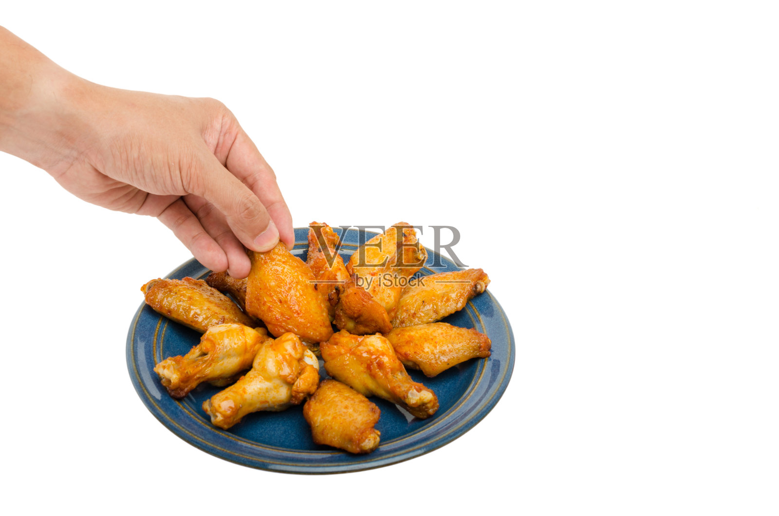 人手烤鸡翅照片摄影图片