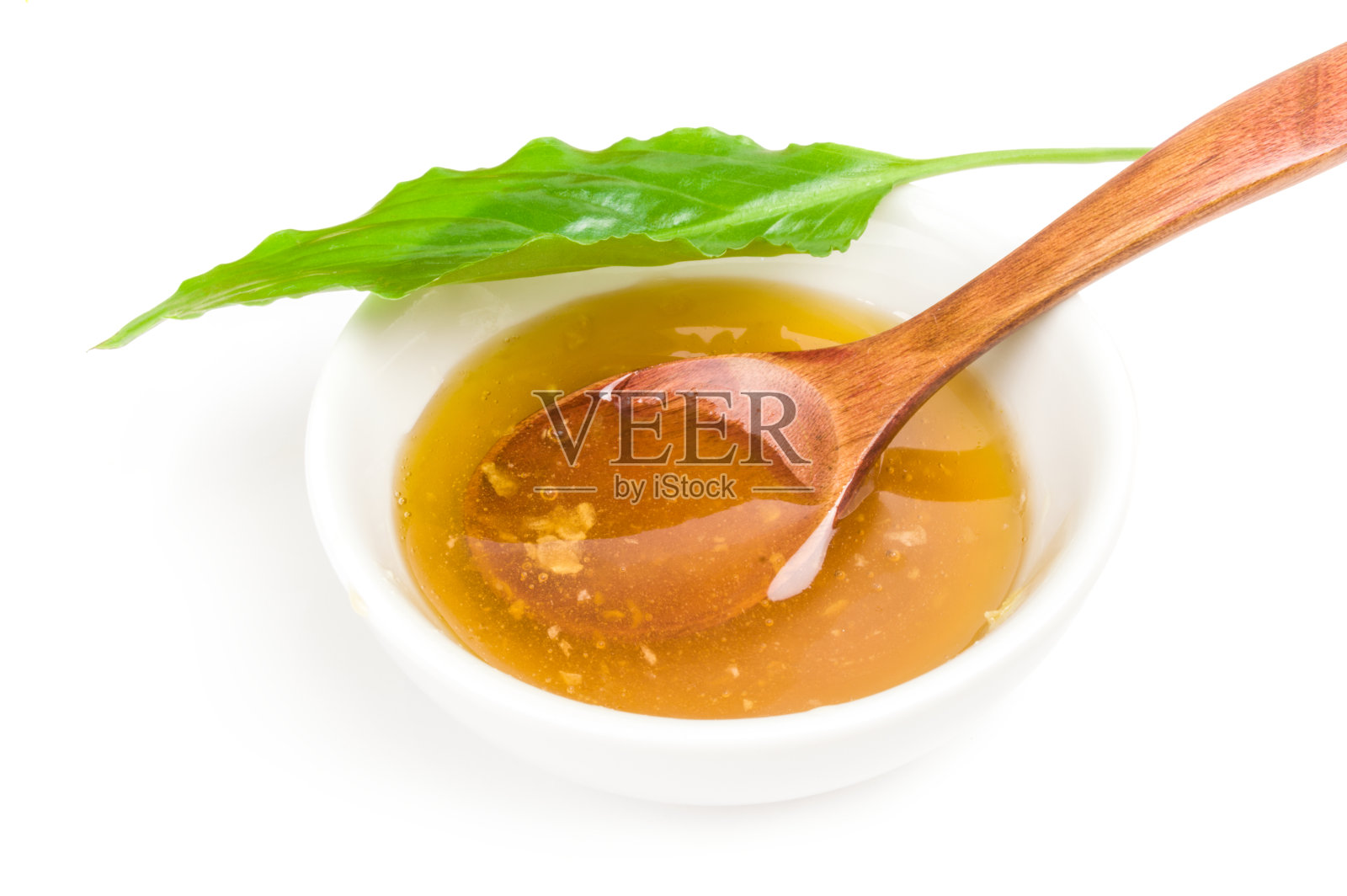 甜蜜的蜂蜜孤立在白色的背景上照片摄影图片