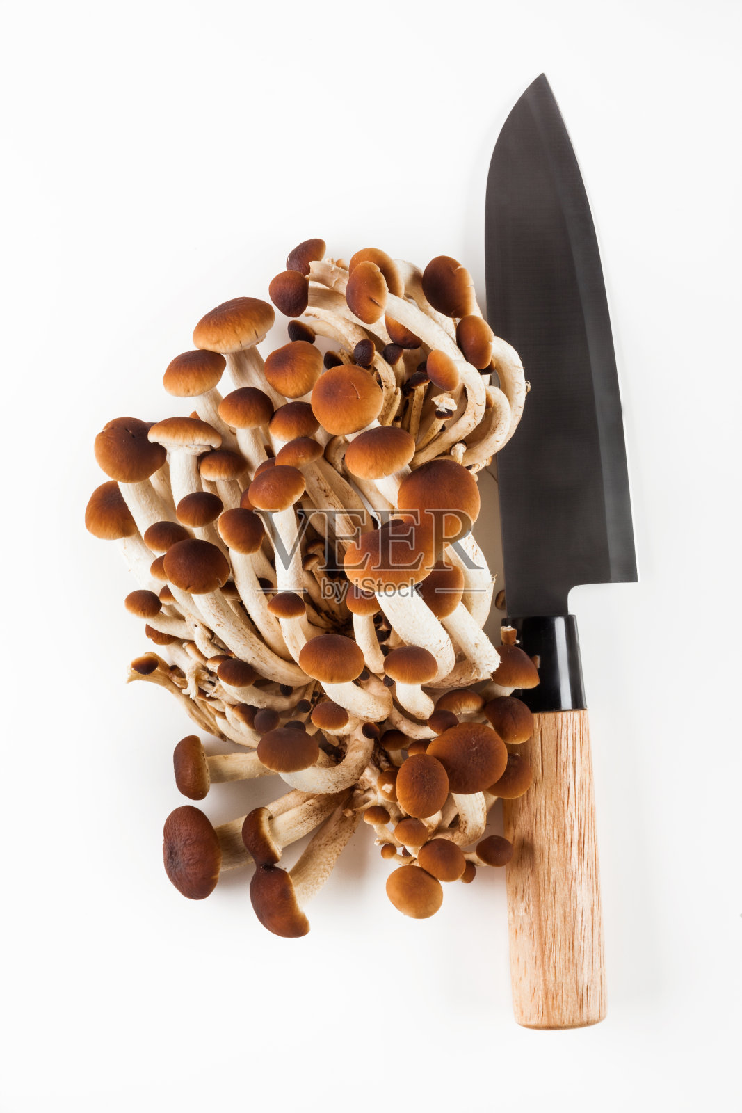 蜂蜜蘑菇和刀放在一张白色的桌子上照片摄影图片