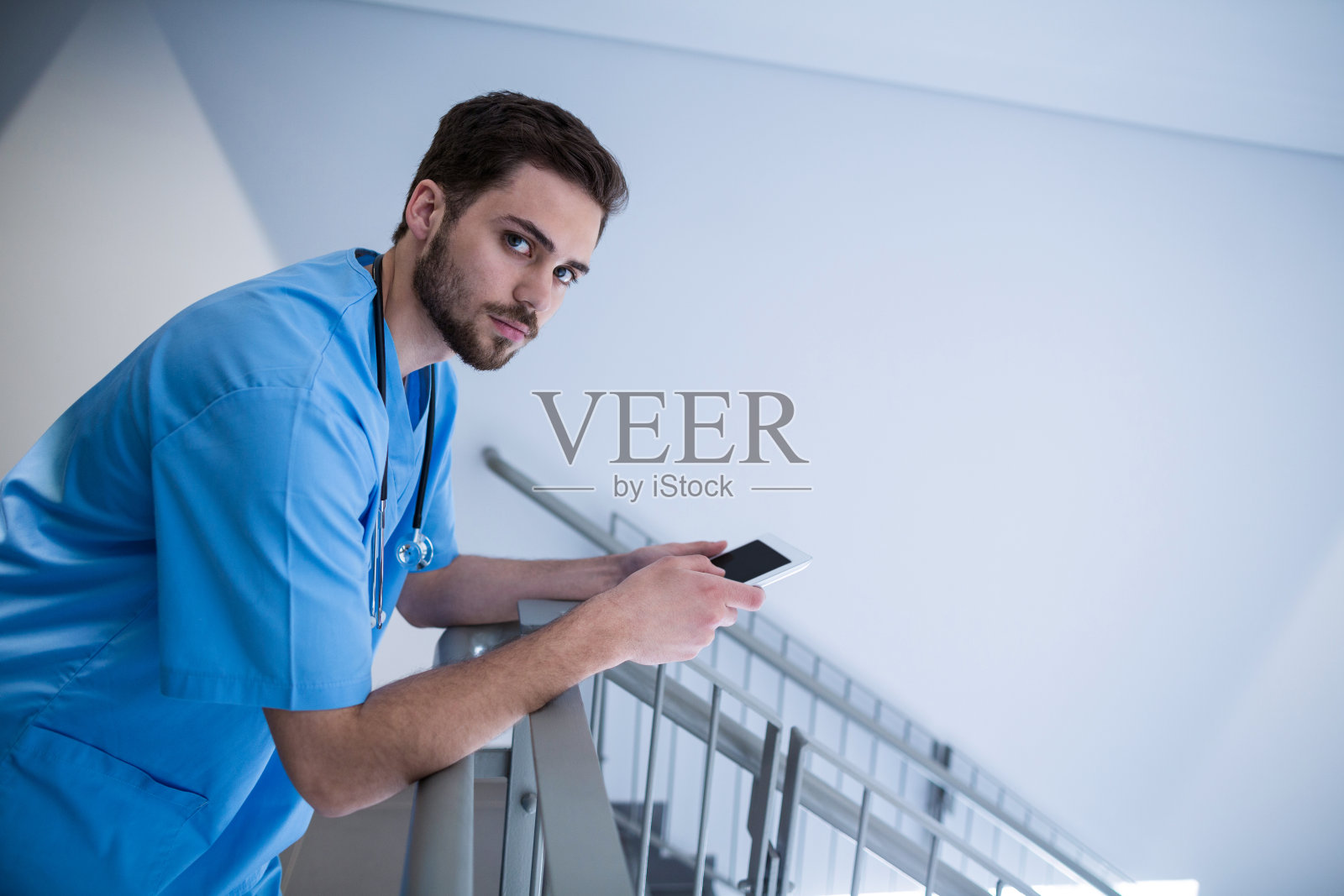 男护士在走廊使用平板电脑的照片照片摄影图片