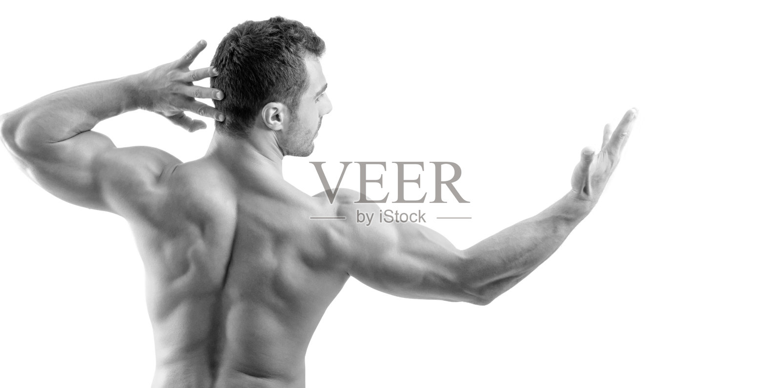 一个健美运动员展示他的背部肌肉孤立在一个白色的背景照片摄影图片