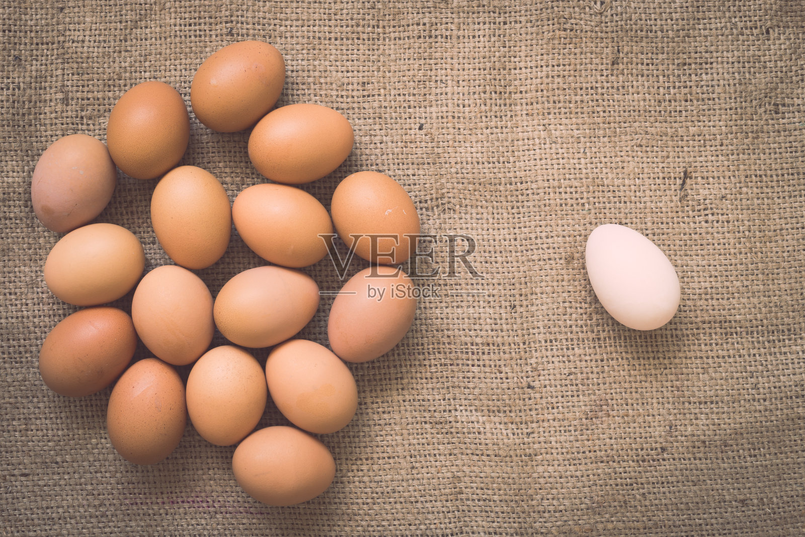 鸡蛋放在旧的皱巴巴的粗麻袋上照片摄影图片