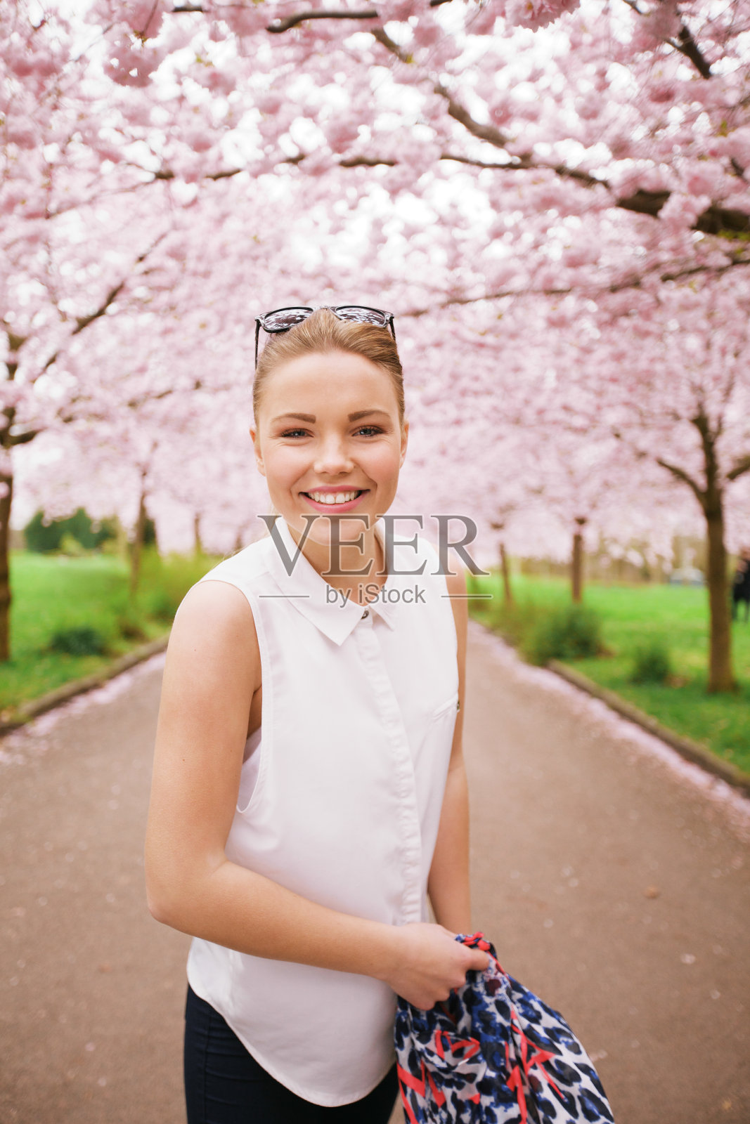 快乐的年轻女子在春天的花园照片摄影图片