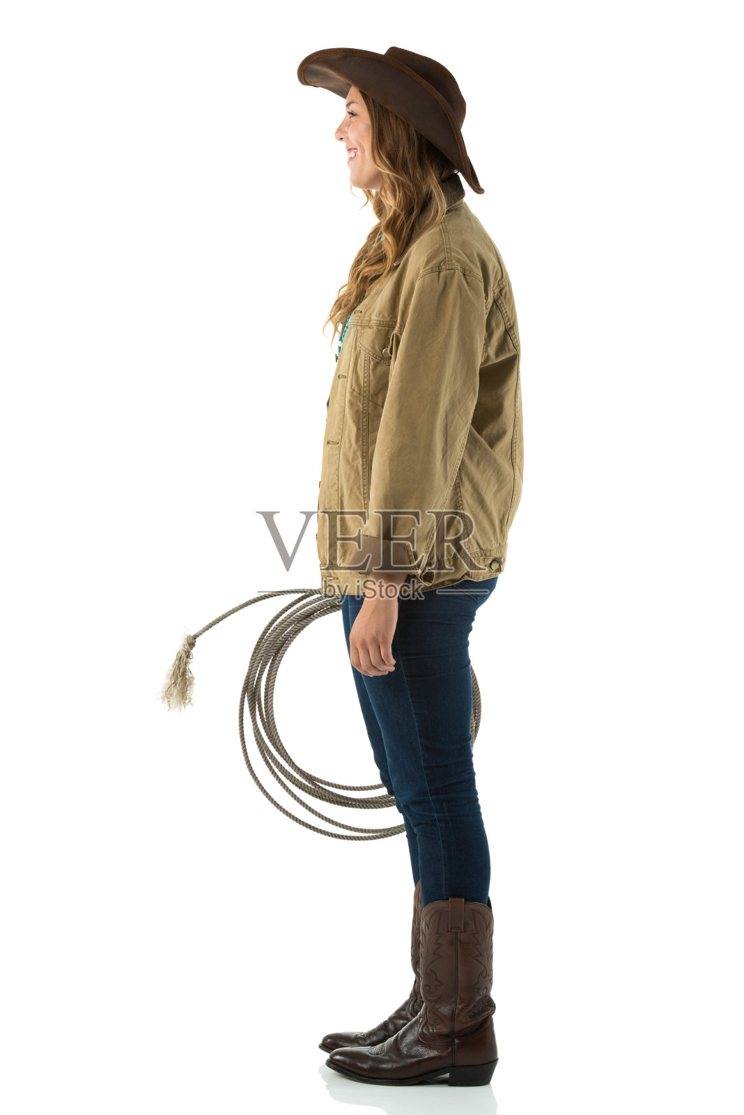 一个戴套索的女牛仔的侧面照片摄影图片