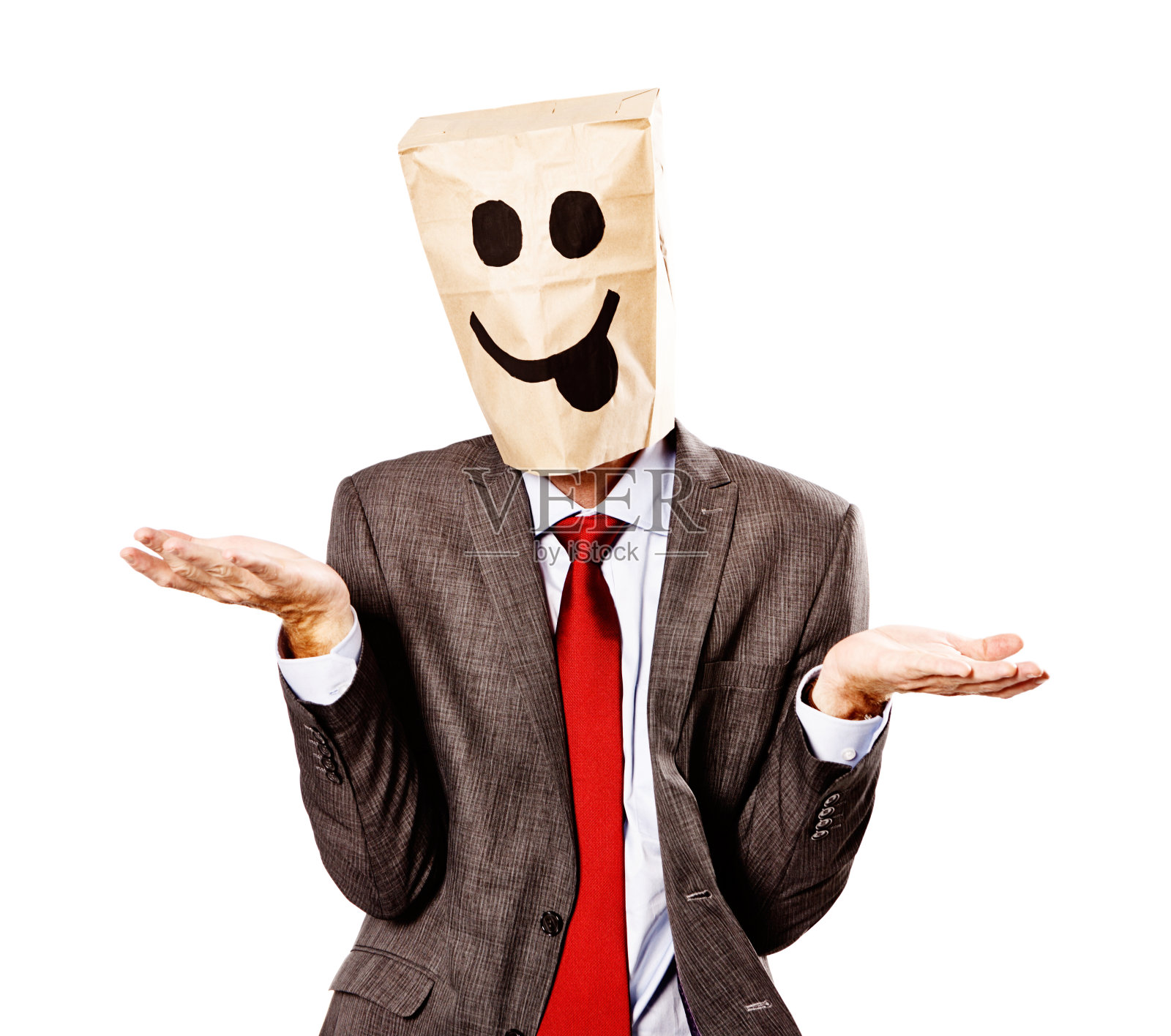 商人戴着傻乎乎的纸袋面具,什么都不知道,耸耸肩照片摄影图片