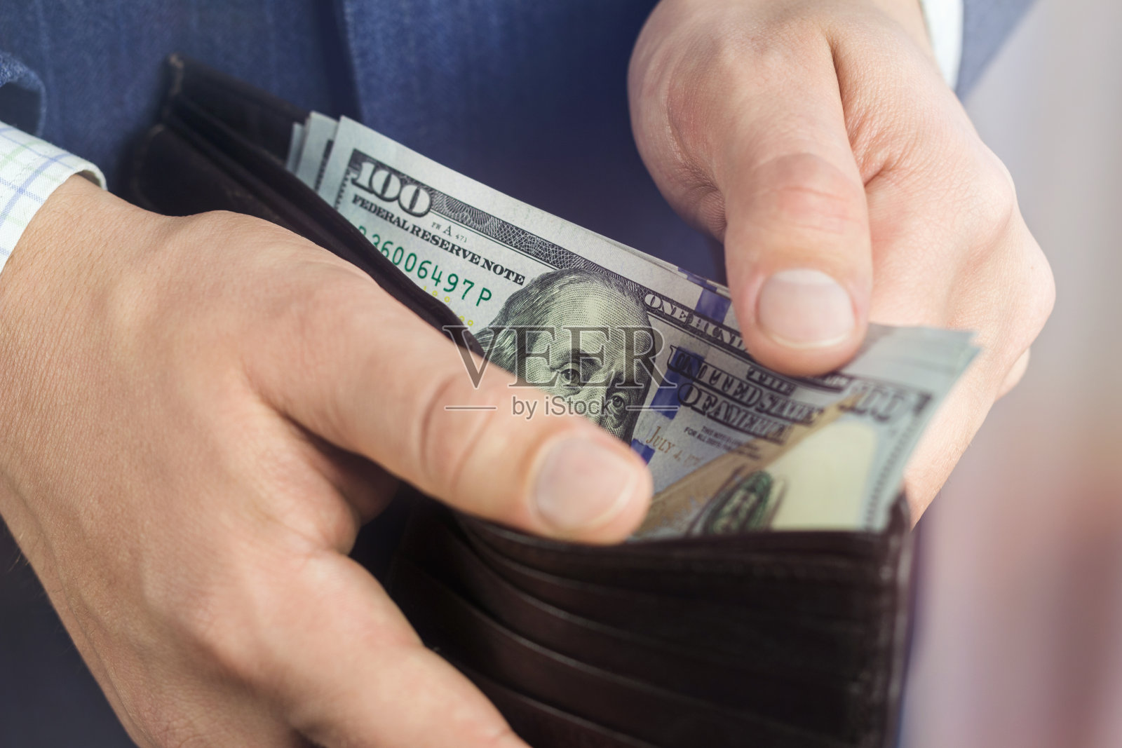 特写的男性手从钱包,商业和金融概念的百元钞票。照片摄影图片