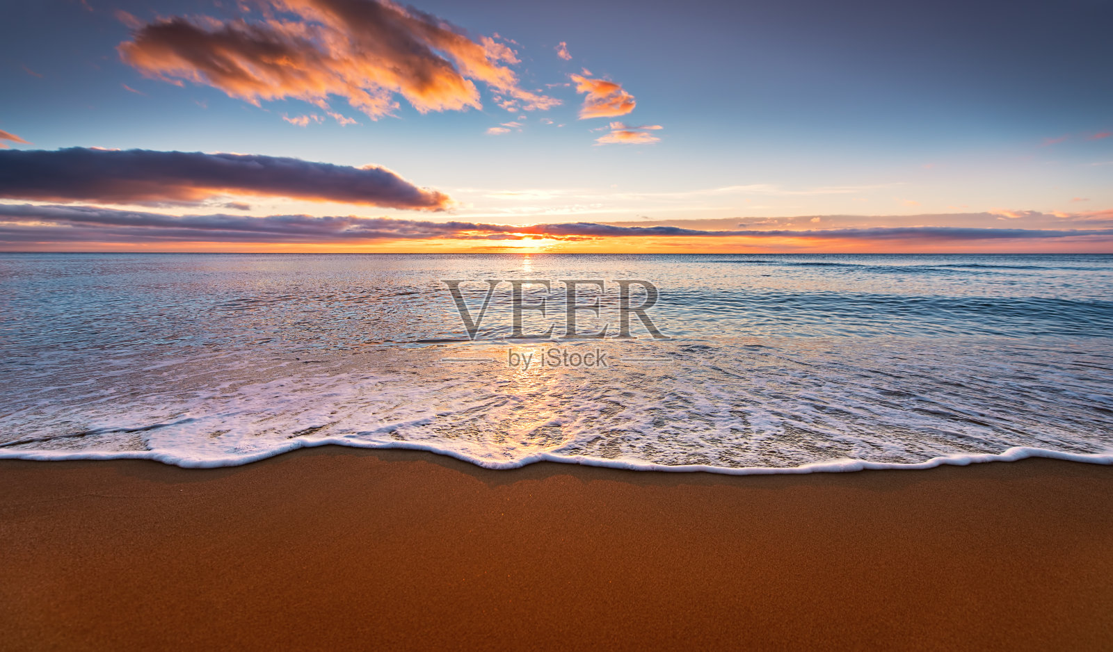 五颜六色的海边沙滩日出。照片摄影图片