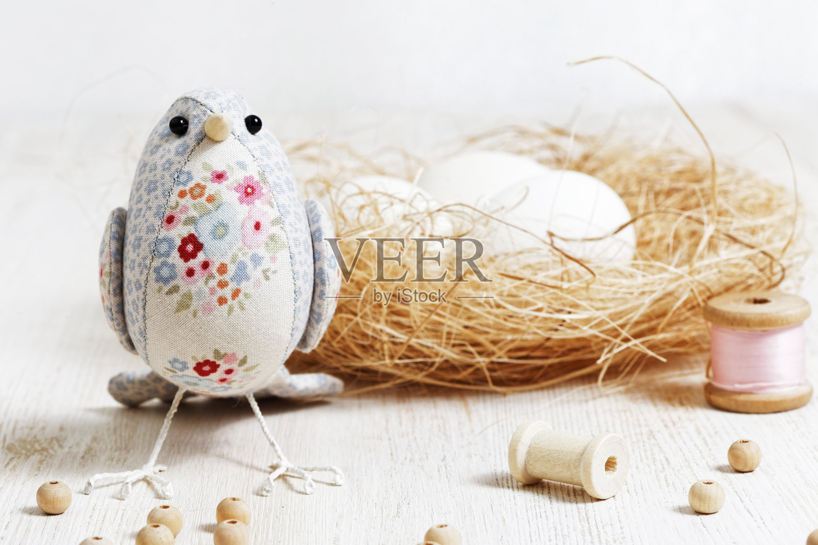 白色木桌上放着一只用布缝成的手工鸟照片摄影图片
