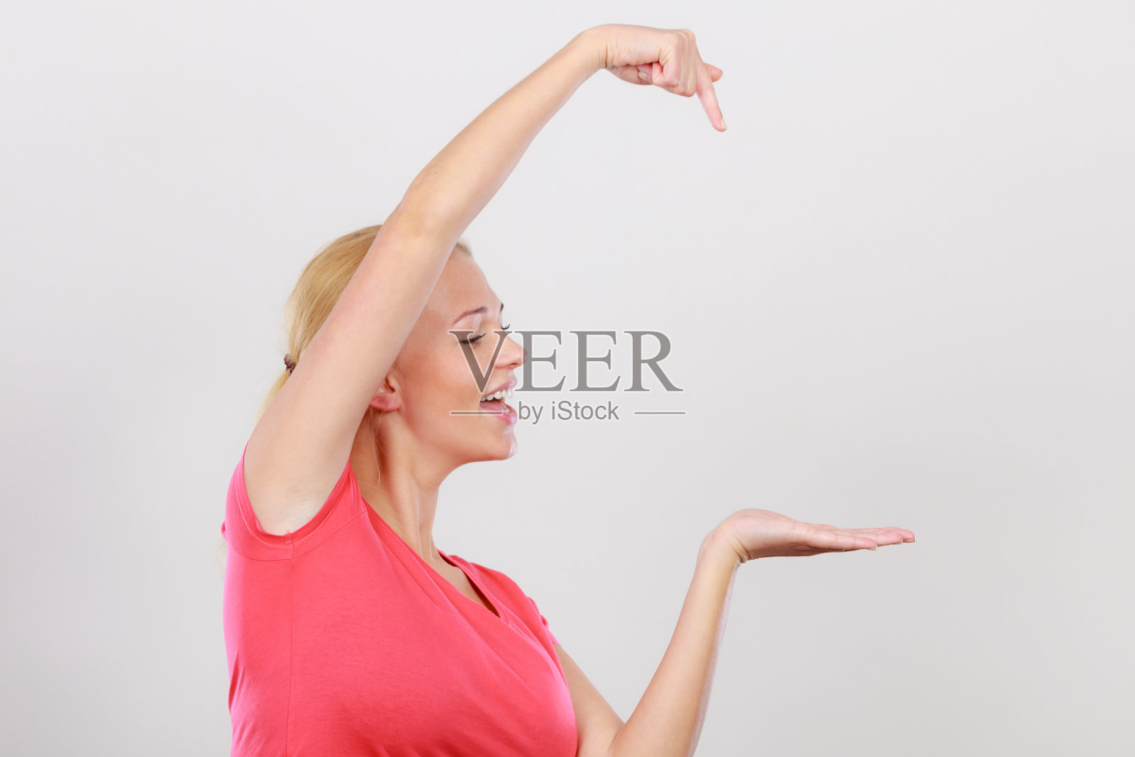 快乐的女人指着右边照片摄影图片