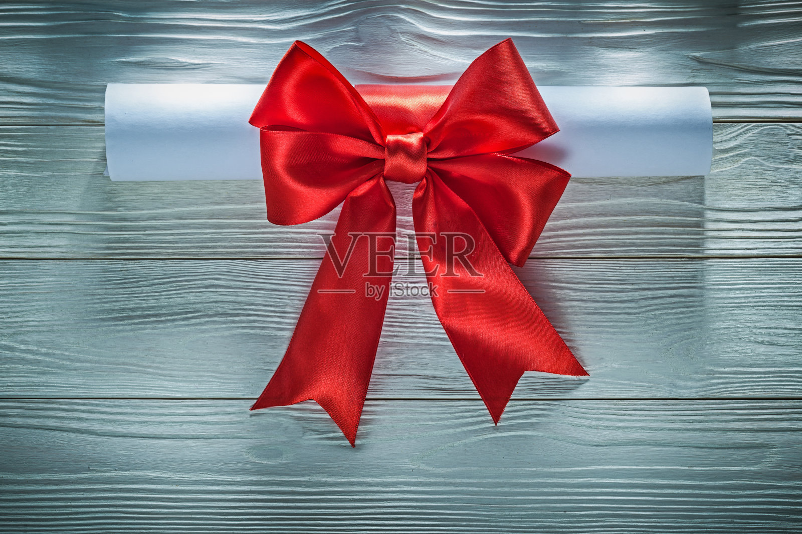 纸卷与红蝴蝶结在木板上横纹照片摄影图片
