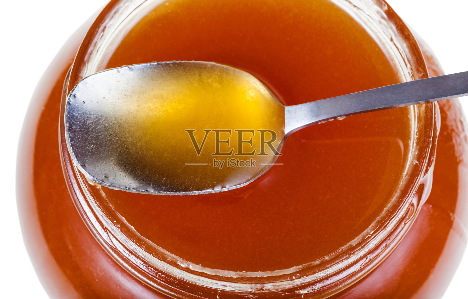 俯视图金属勺子上的玻璃罐与蜂蜜照片摄影图片