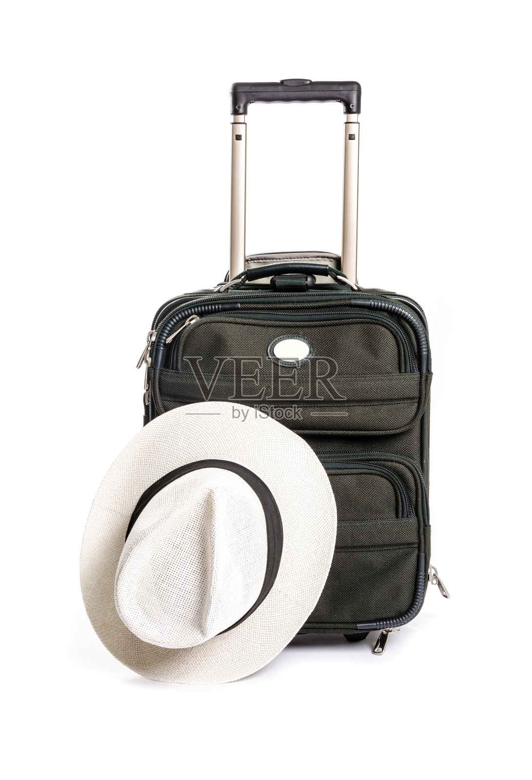 绿色随身行李和一顶白色草帽照片摄影图片