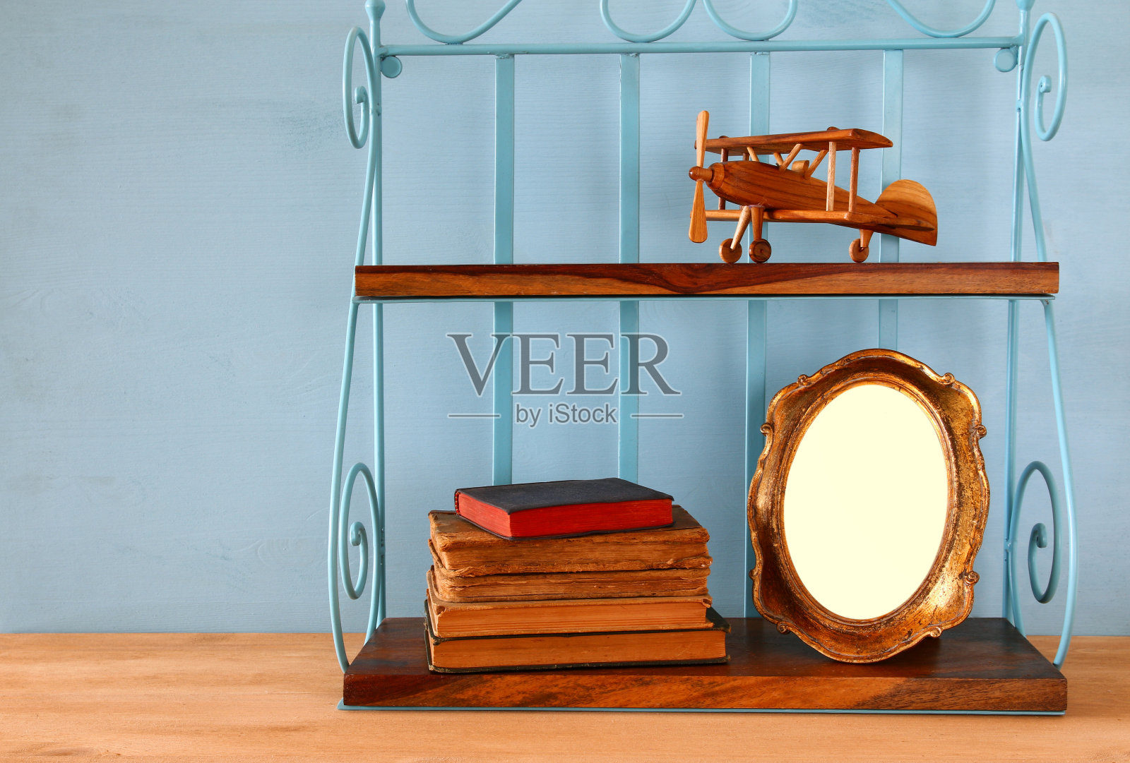 古董架子与旧木制飞机玩具,书籍和空白相框照片摄影图片