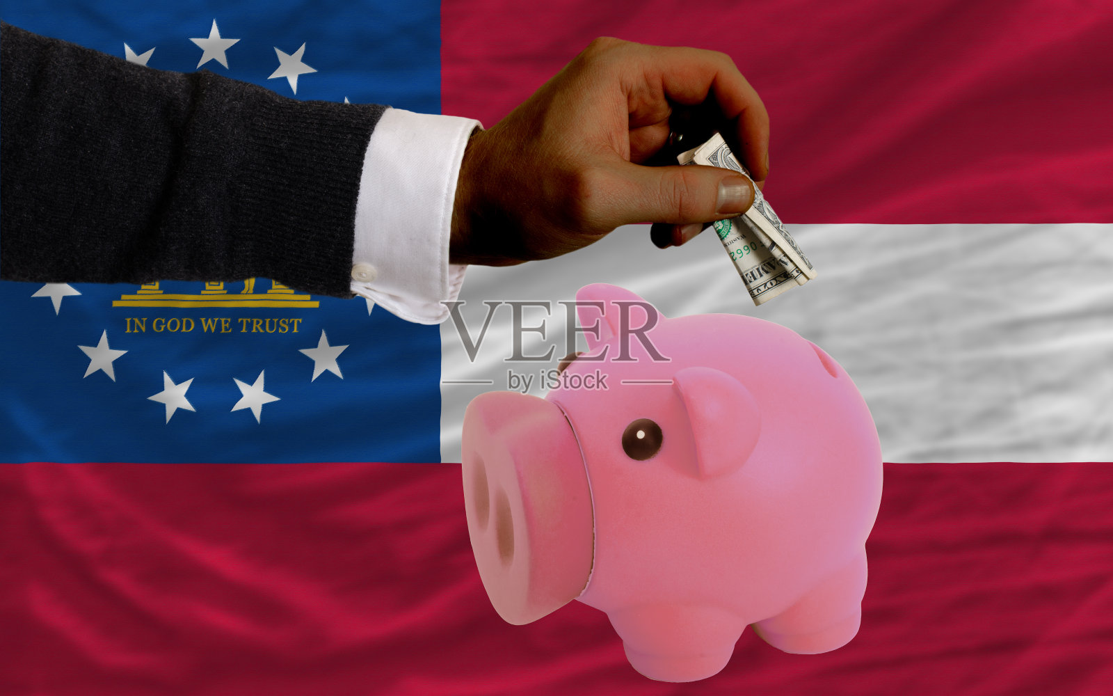 美元变成了存钱罐和乔治亚州的国旗照片摄影图片