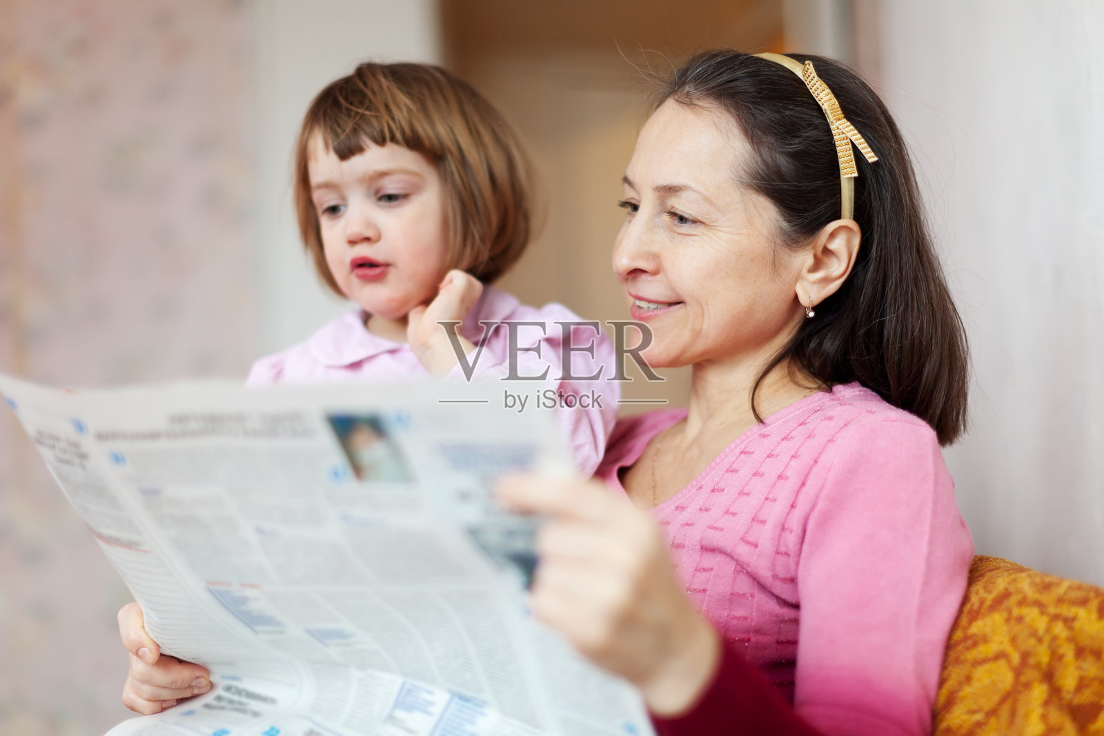看报纸的成熟妇女和儿童照片摄影图片