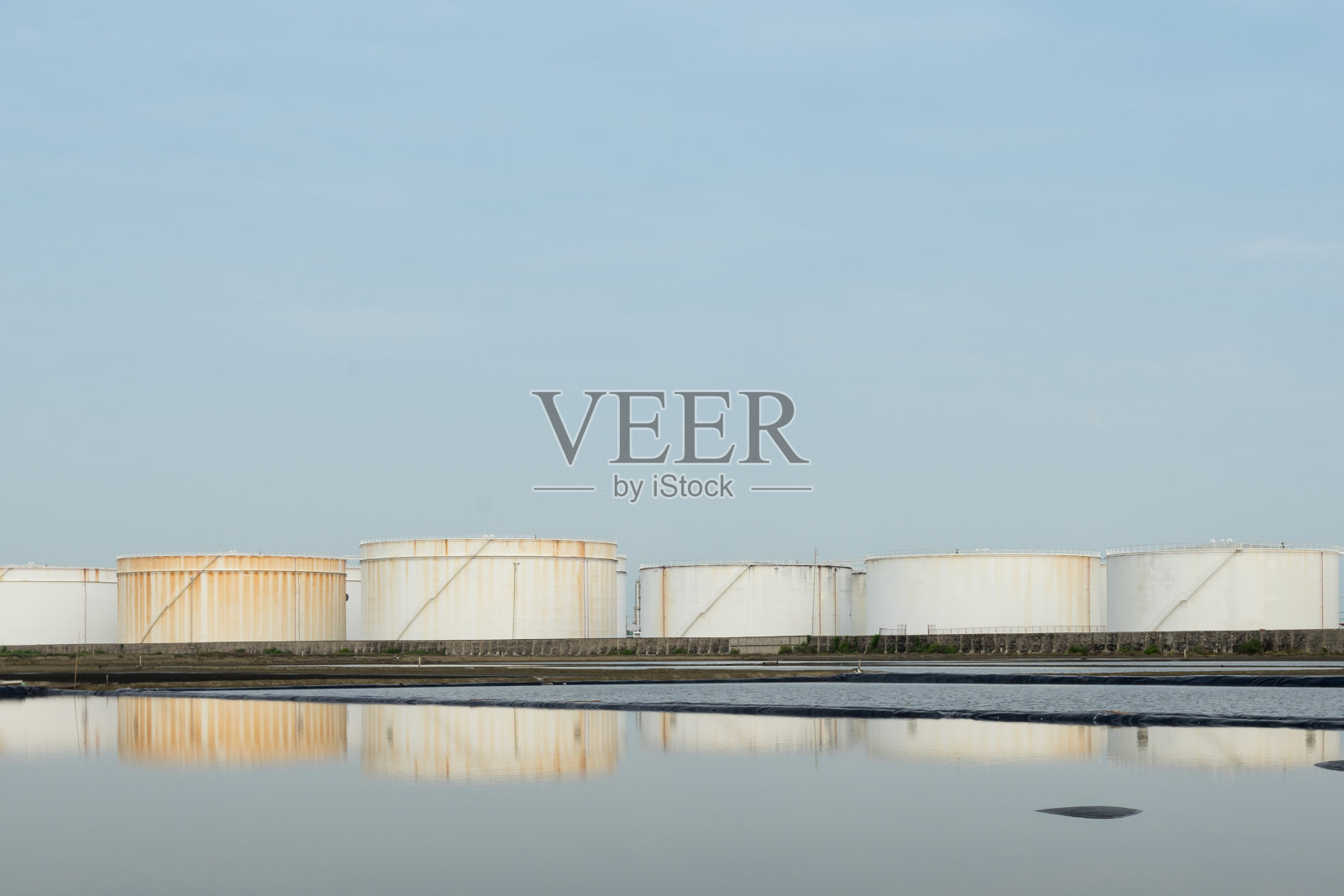 蓝天沼泽的油罐照片摄影图片