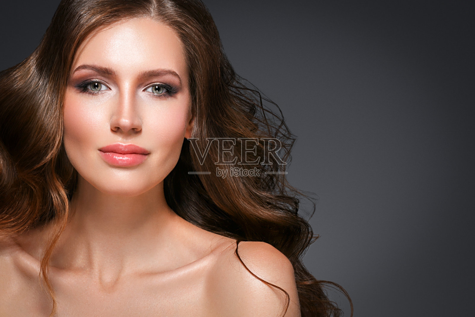 美丽的头发女人美丽的皮肤肖像在黑暗的背景。长美丽健康的头发模特女孩库存形象。照片摄影图片