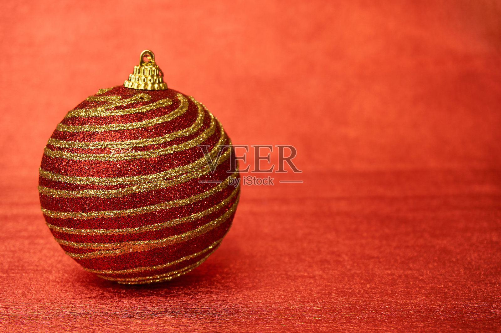 红色圣诞玩具与金色条纹红色背景特写。新年,圣诞背景。照片摄影图片