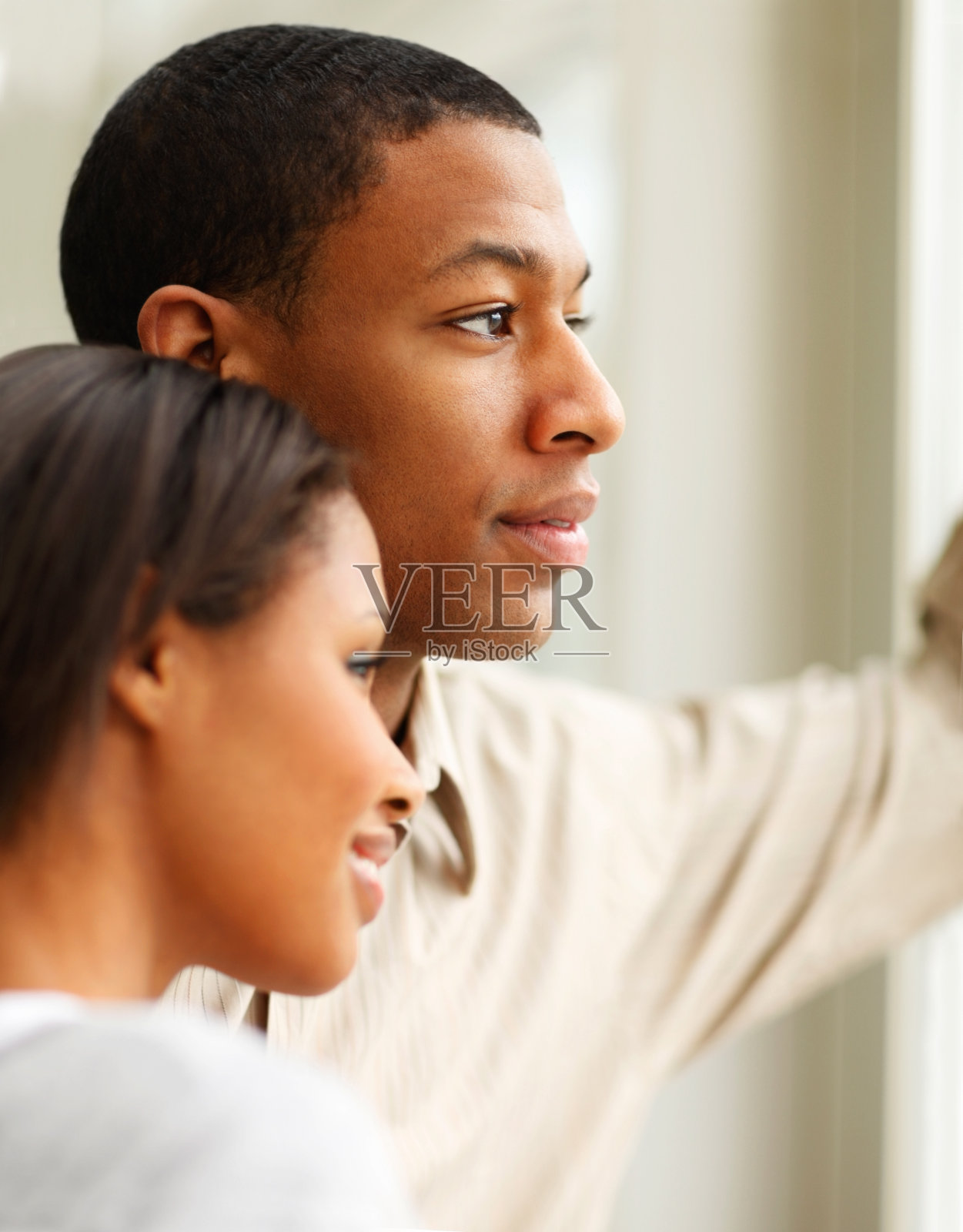 一对年轻夫妇从窗户往里看照片摄影图片