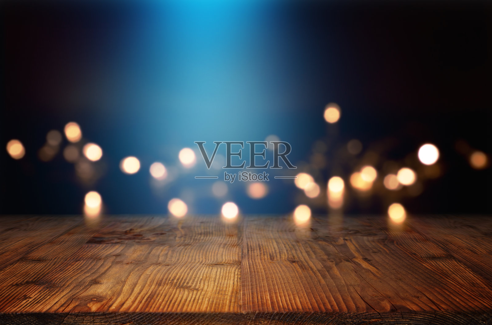 散景背景用蓝色光束和一张木桌照片摄影图片