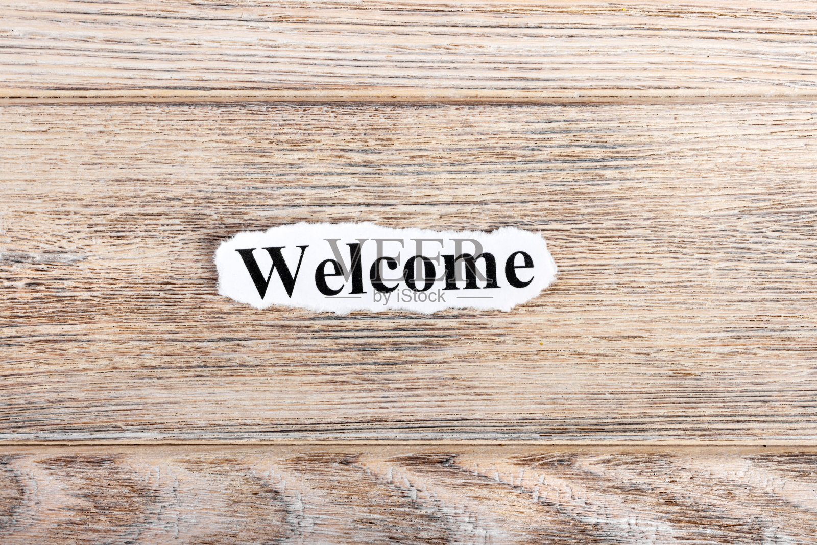 欢迎文字。撕纸上的欢迎字。概念的形象照片摄影图片