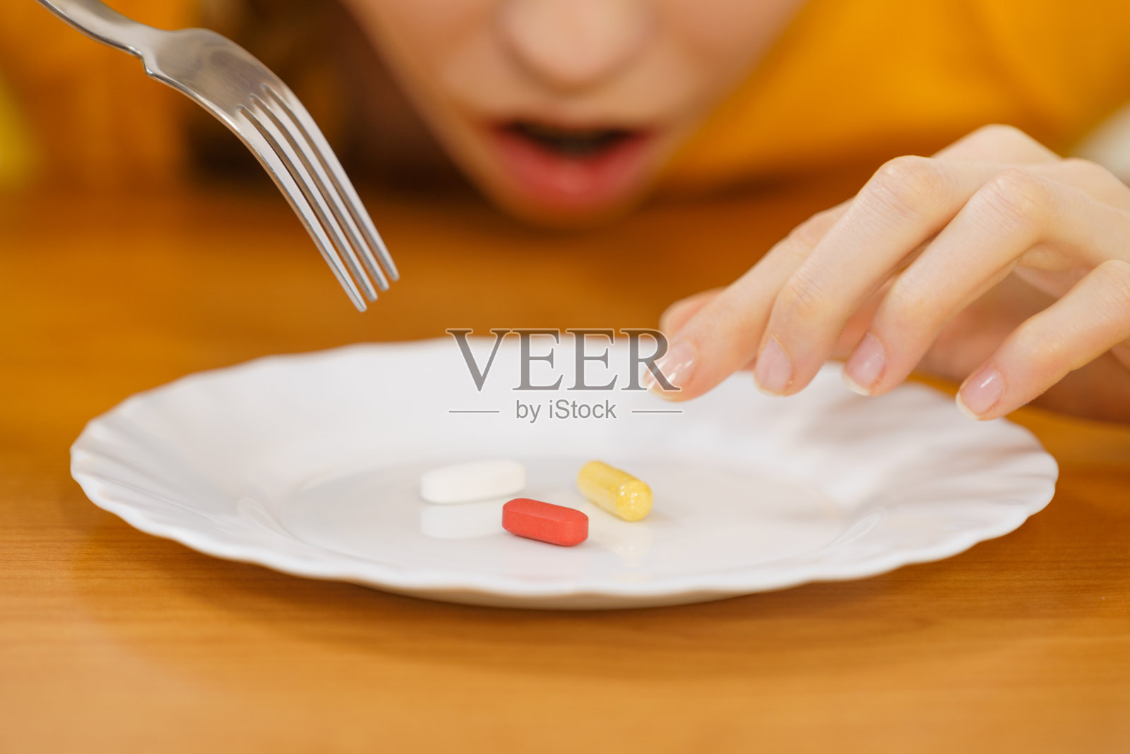 盘子里有药片的震惊女人照片摄影图片