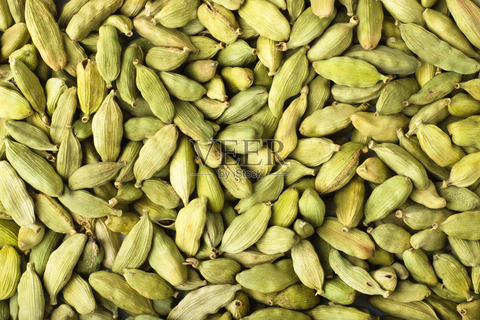 以小豆蔻籽为调料背景,质地自然照片摄影图片