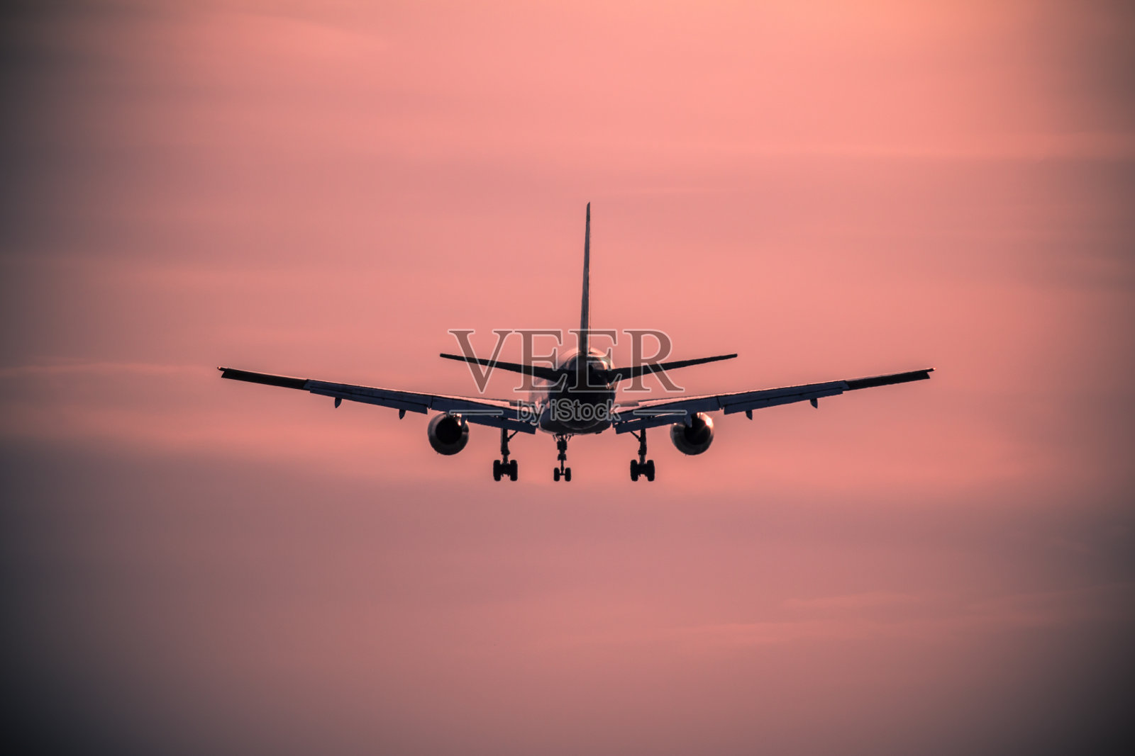 日落时飞机降落照片摄影图片