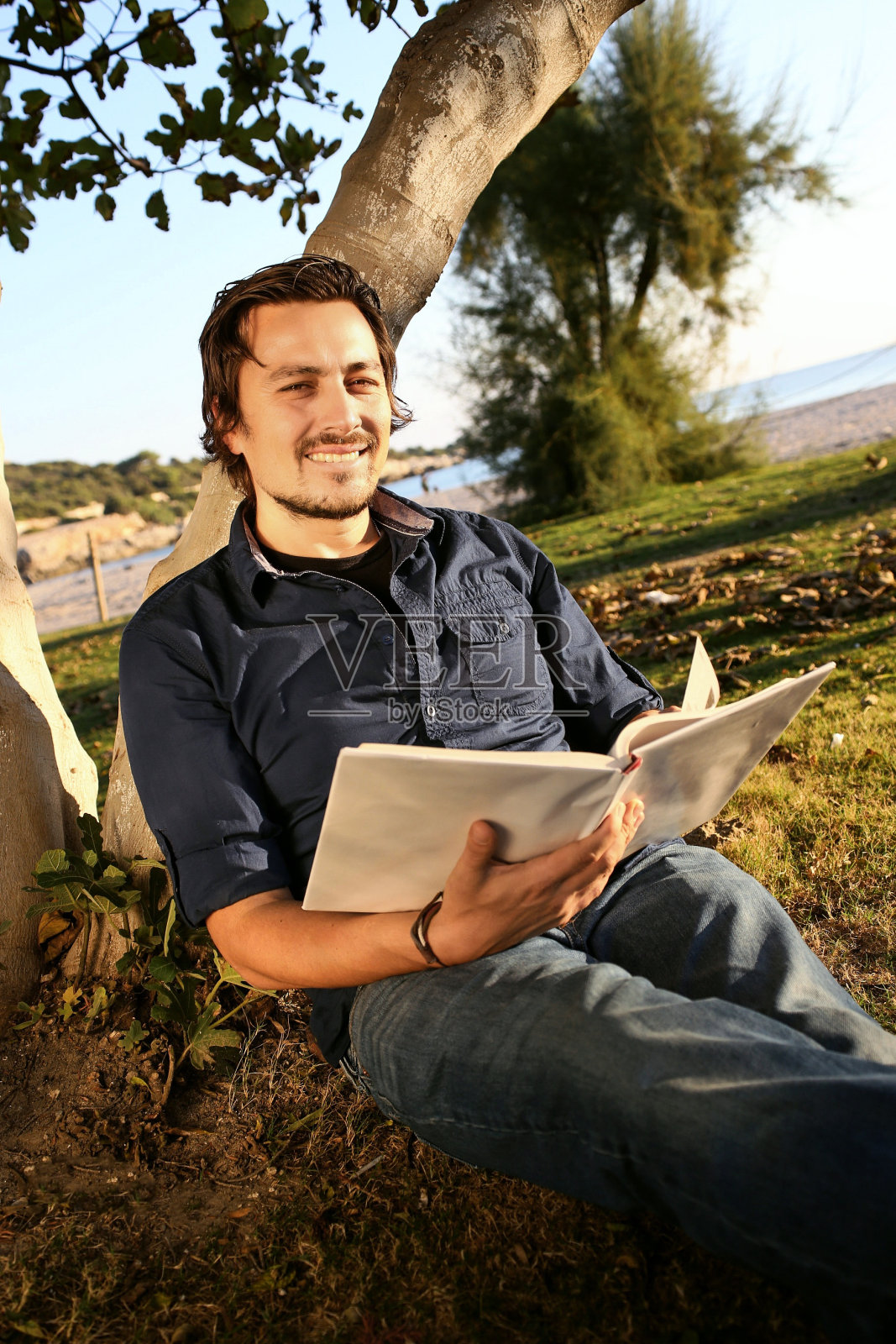 英俊的男人在读书照片摄影图片