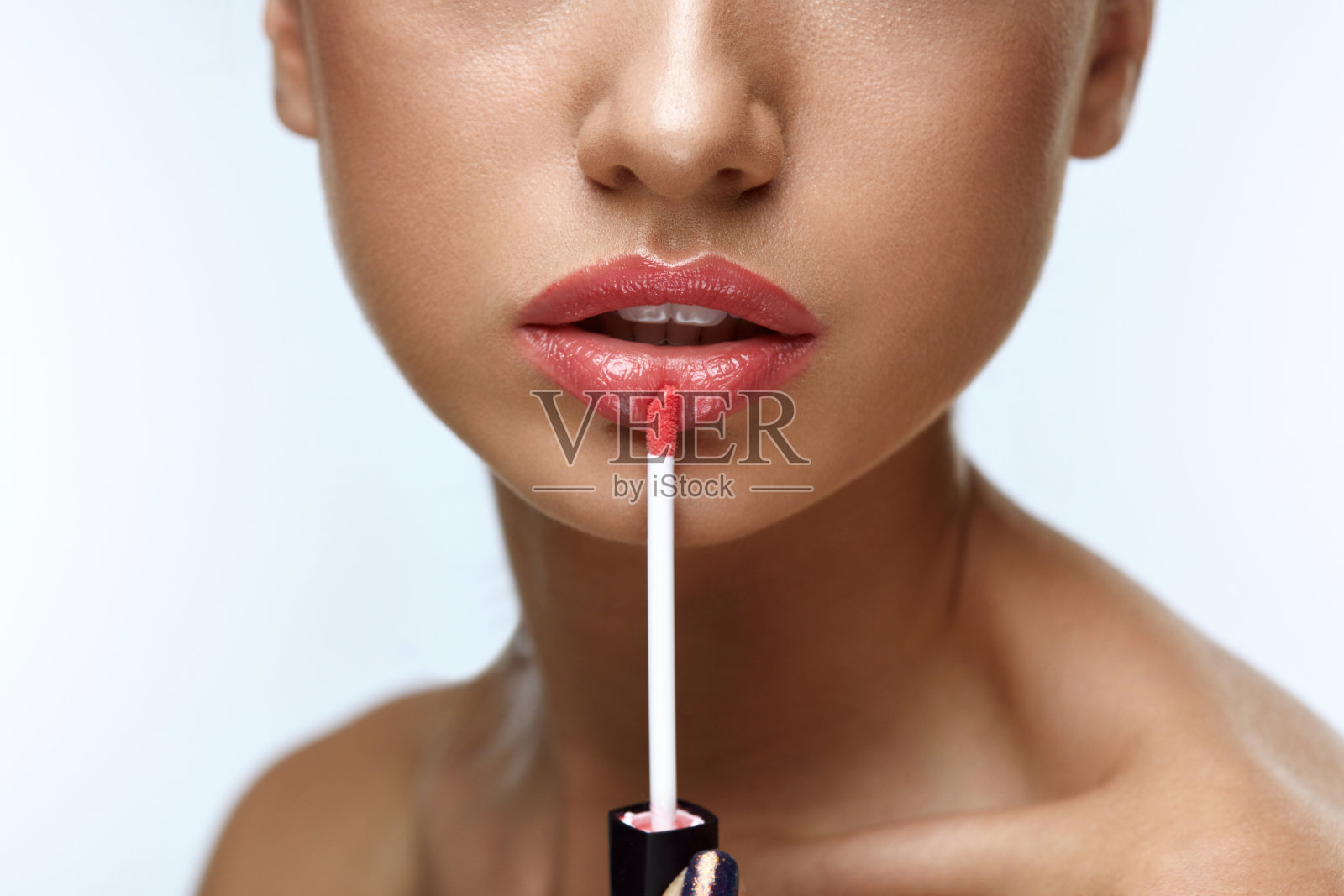 美容化妆。美丽女人用唇彩照片摄影图片