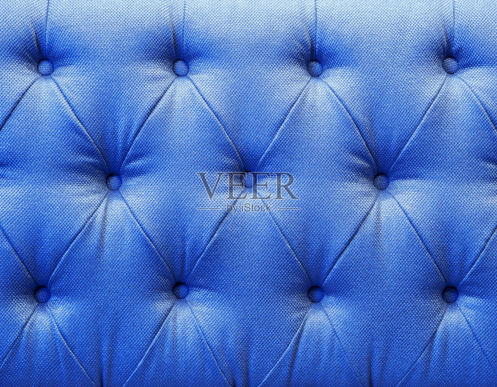 沙发中毛绒蓝色皮革纹理的背景图像。照片摄影图片