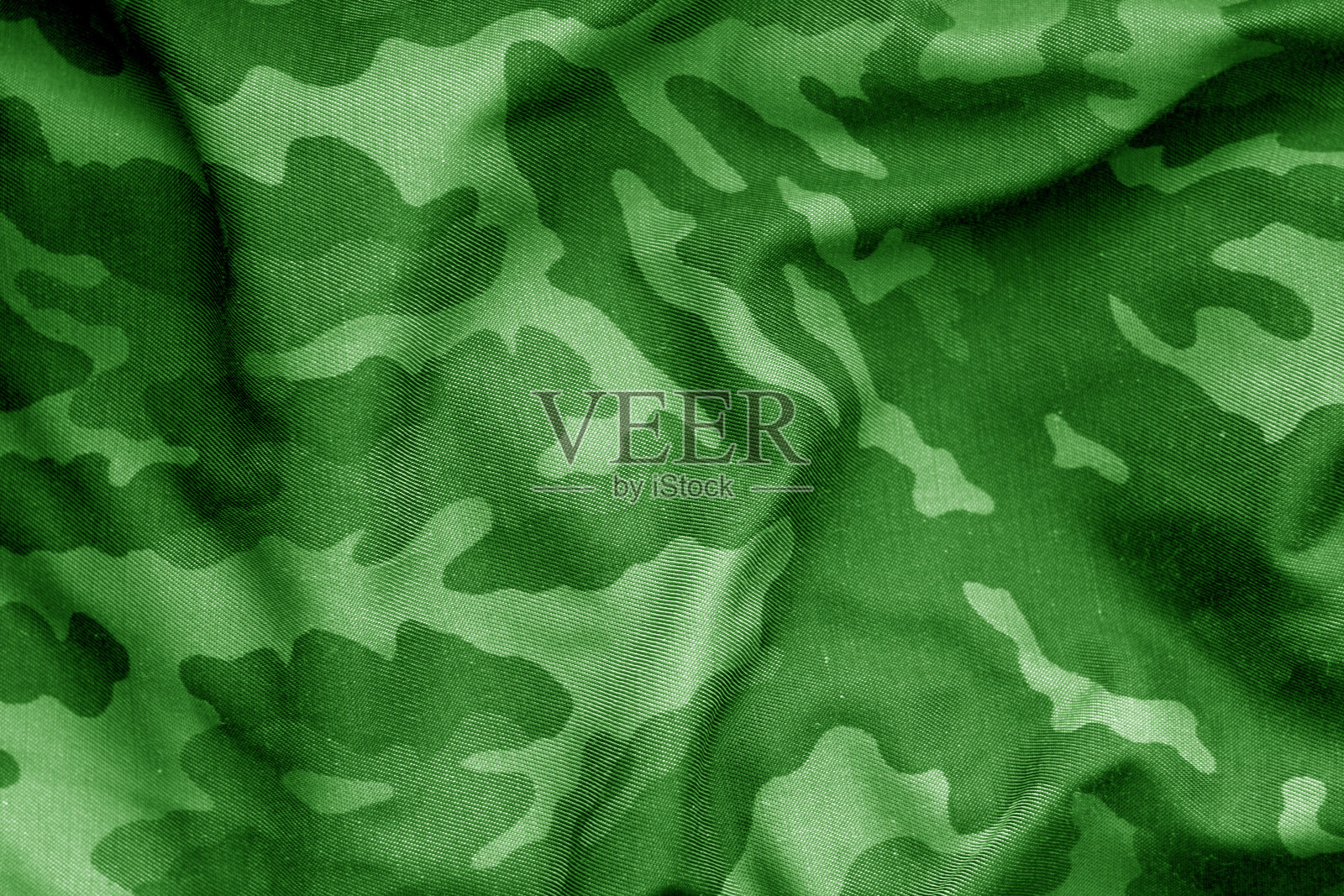 军服图案,绿色色调有模糊效果。照片摄影图片