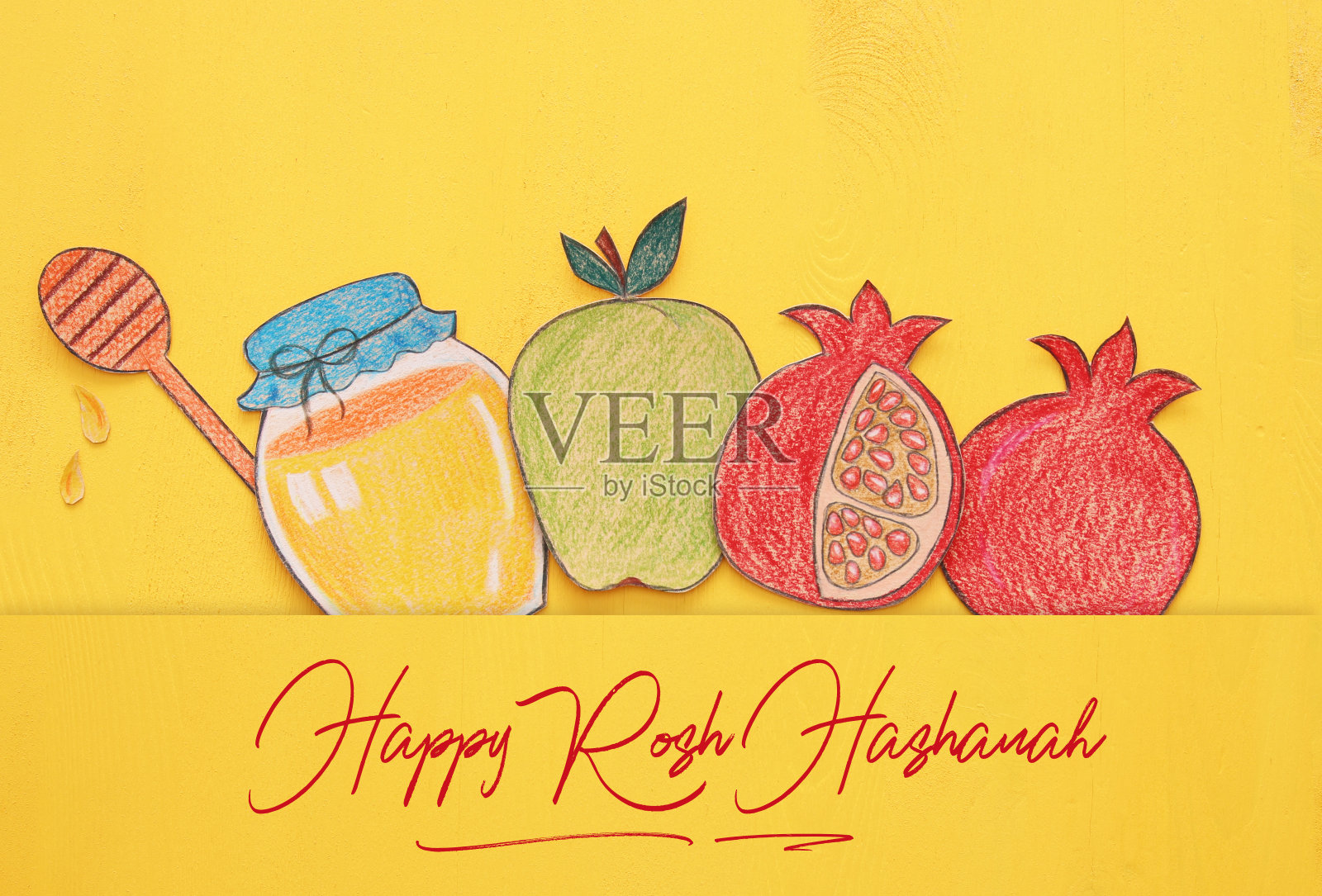 犹太新年的概念。传统符号形状从纸上剪下来,然后涂上颜料。照片摄影图片