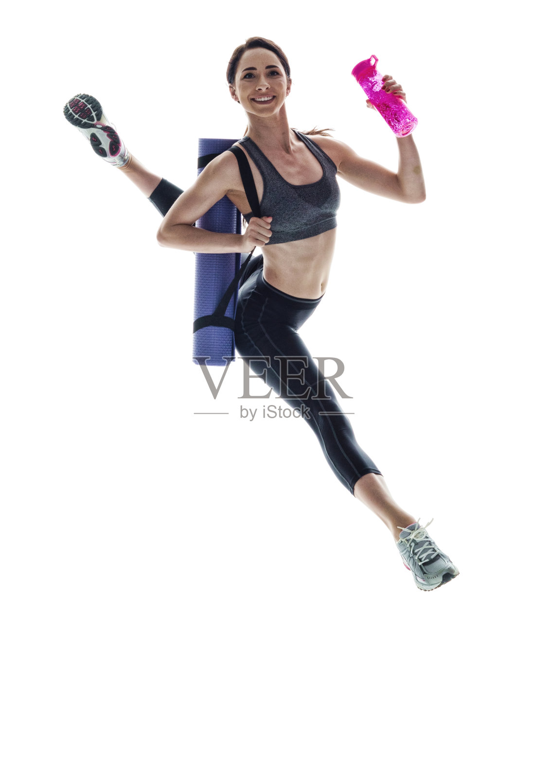 迷人的运动女人在半空中跳跃与运动衣服照片摄影图片