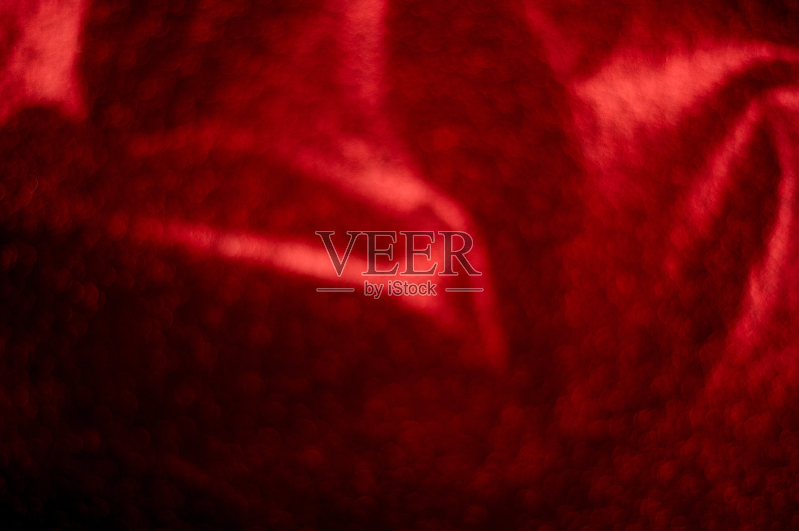 背景是红色的,图像是模糊的,散景有一个闪烁的光。这里有一个复制空间。照片摄影图片