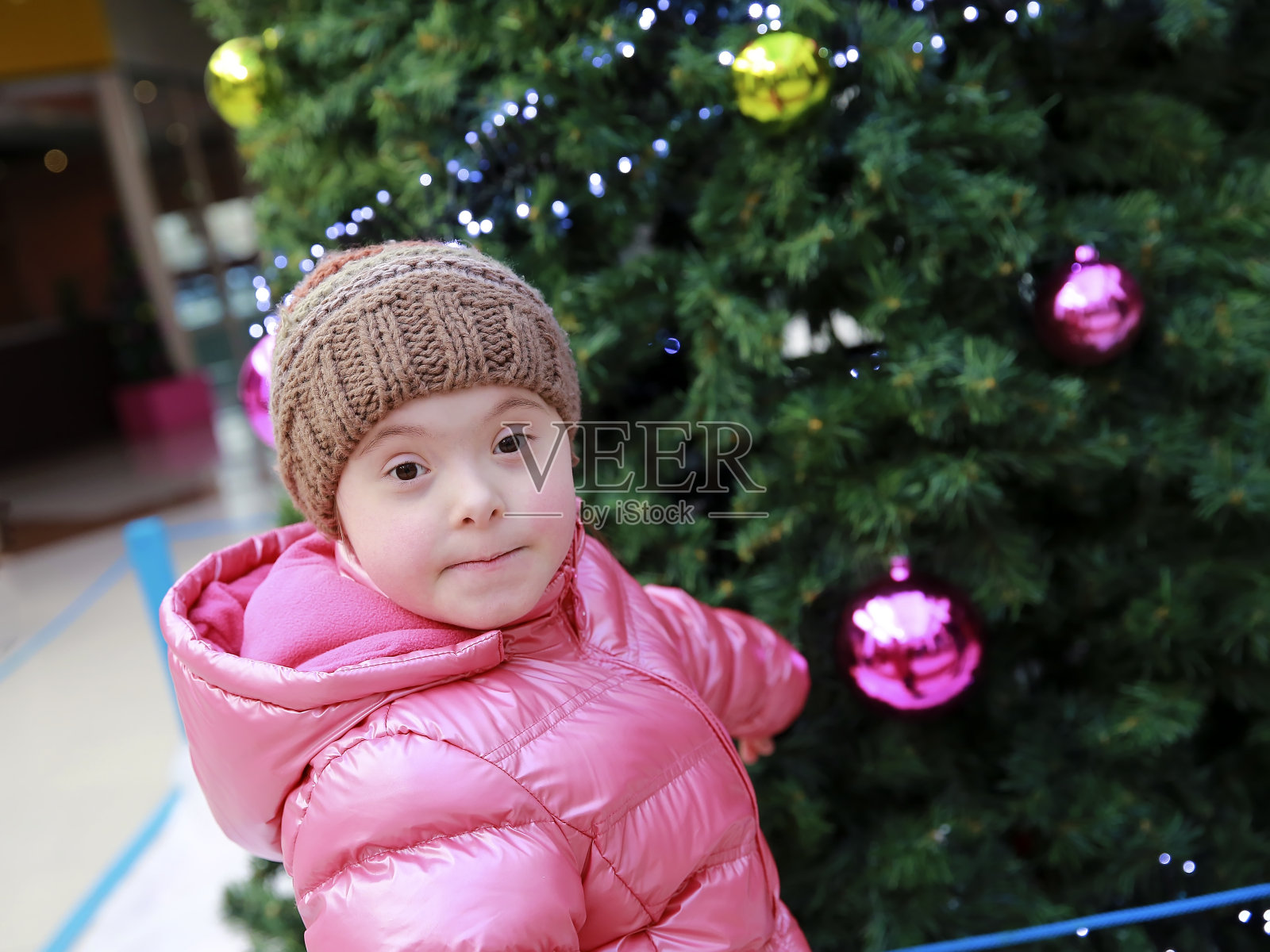 圣诞树背景前的年轻女孩肖像照片摄影图片
