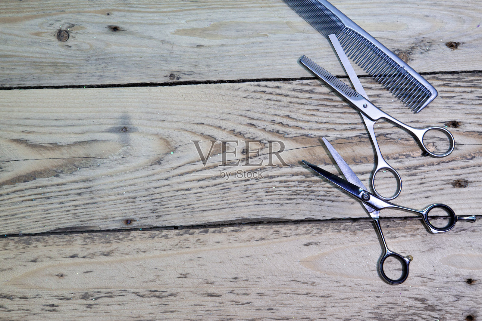理发师用的剪刀放在一块木板上照片摄影图片