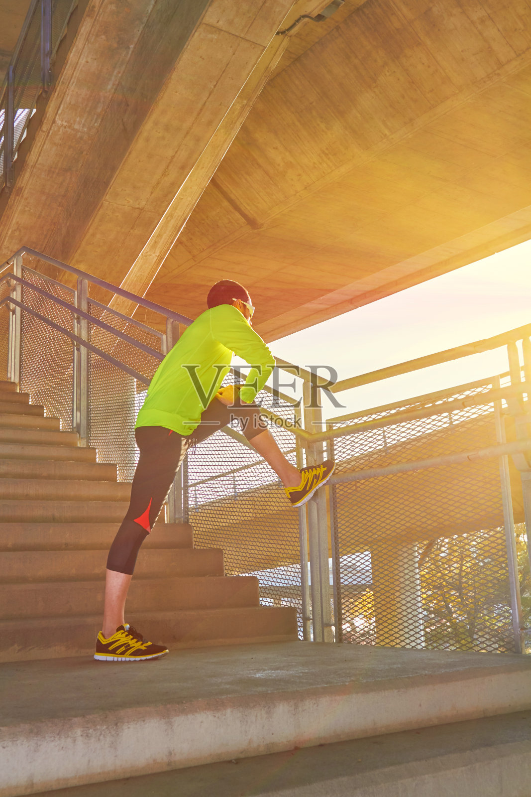 在一座大城市的桥梁上锻炼/慢跑的运动员。照片摄影图片