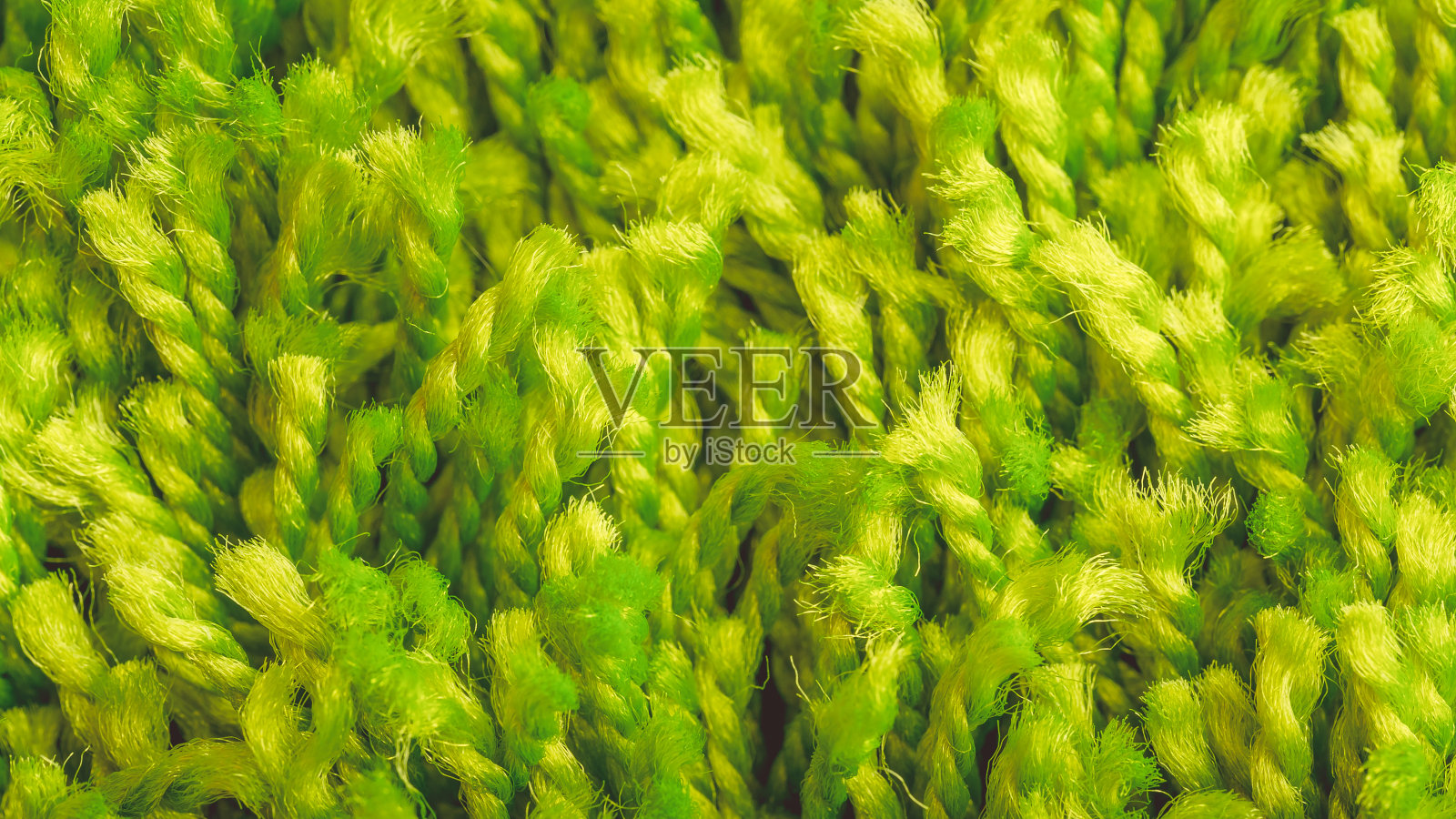 绿色的纱线和织物,地毯的特写镜头。照片摄影图片