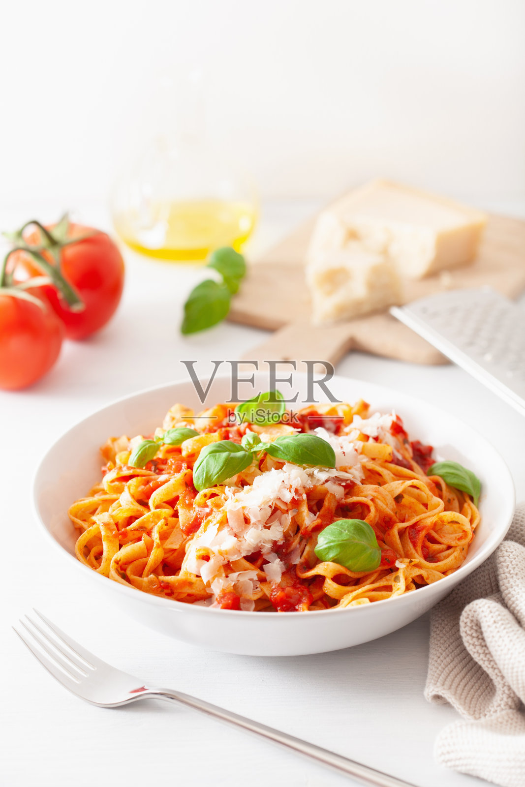 意大利面加番茄酱,帕玛森罗勒照片摄影图片