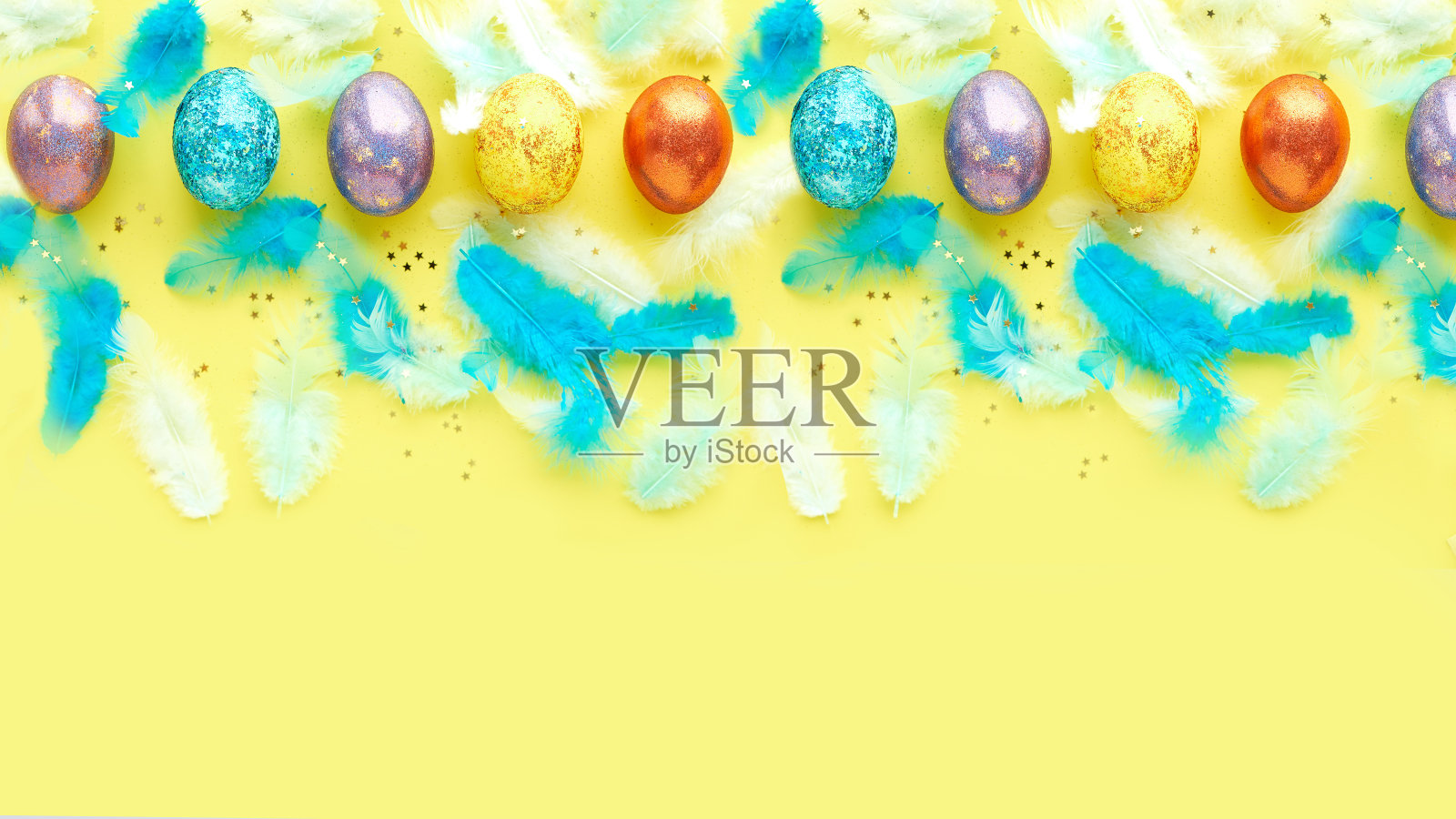 黄色背景上的方形复活节彩蛋。分散的蓝色羽毛。横幅的文本照片摄影图片
