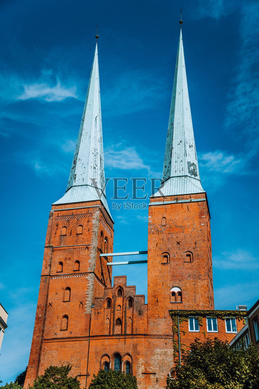 吕贝克大教堂的景色。两座塔由红砖和翠绿的教堂尖顶组成。石勒苏益格-荷尔斯泰因州,德国北部。照片摄影图片