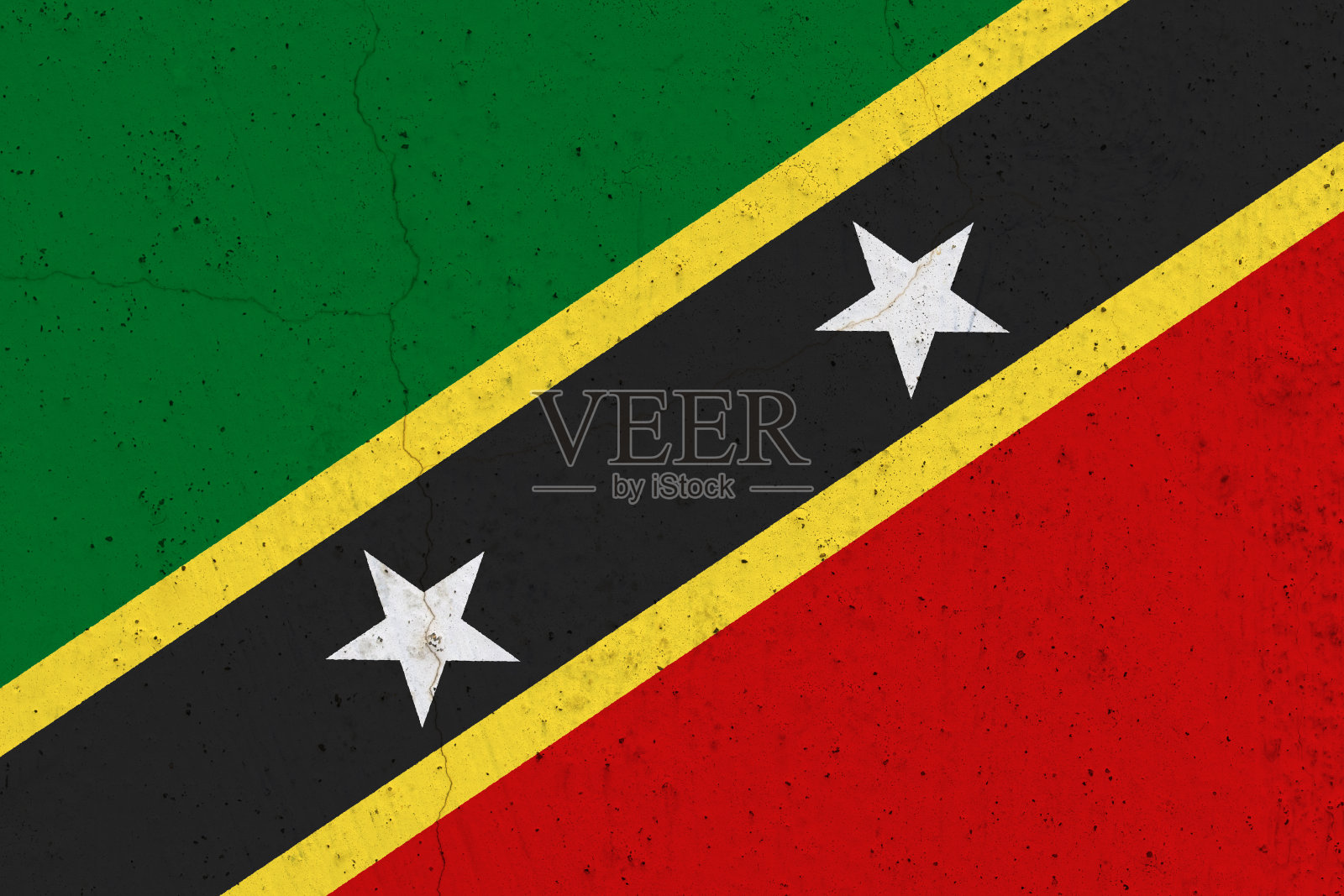 混凝土墙上挂着圣基茨和尼维斯的旗帜照片摄影图片