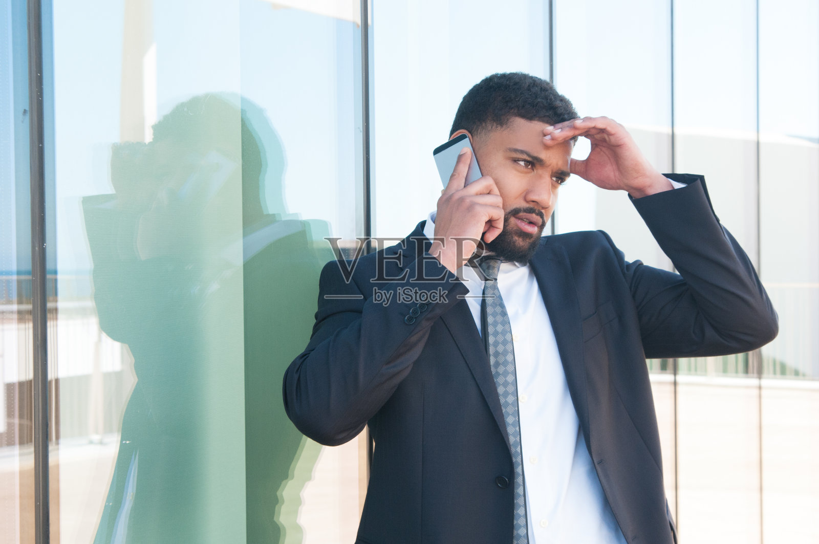 忧心忡忡的商人在电话里说照片摄影图片