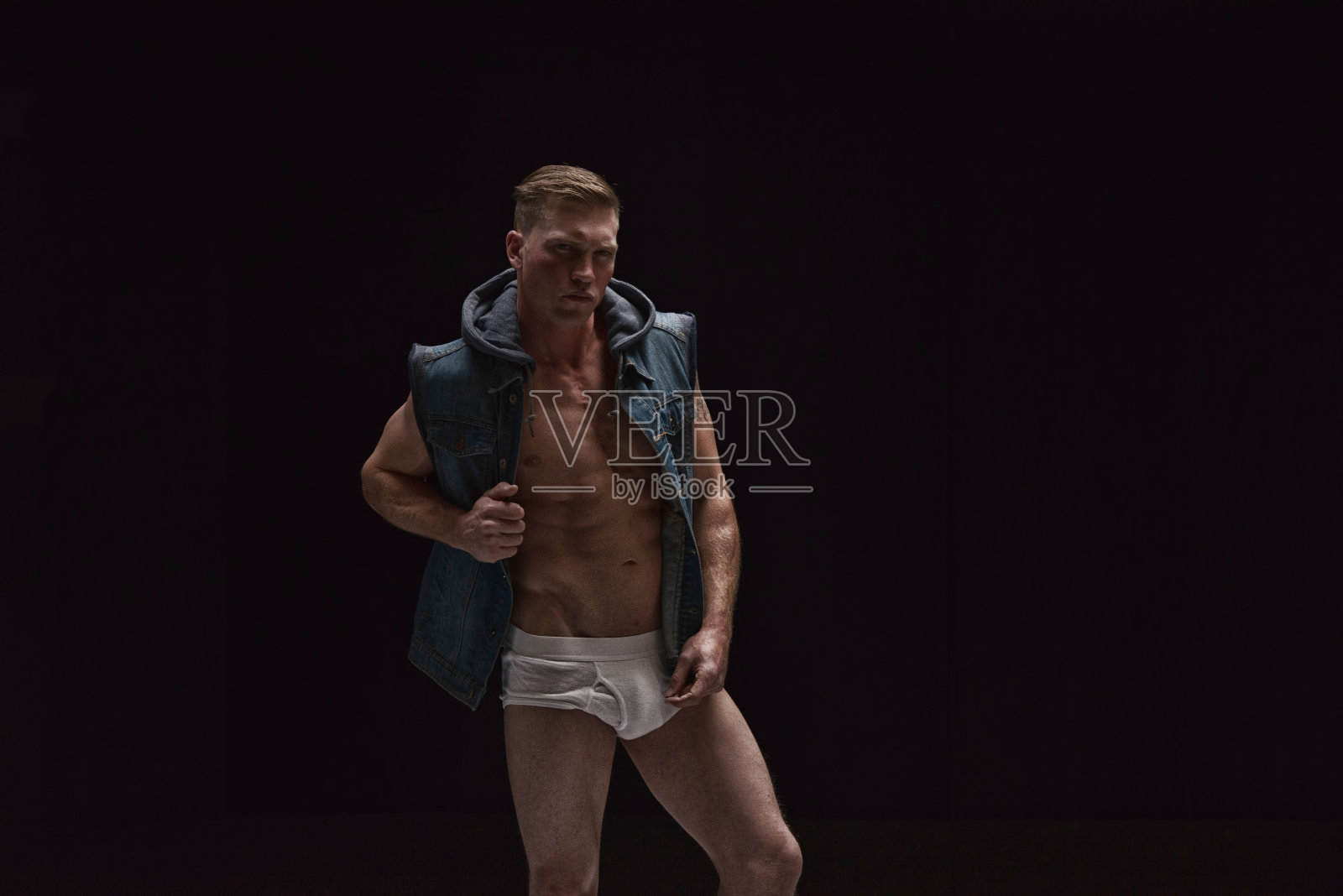 性感的男人只穿一件背心和内衣,是赤膊照片摄影图片